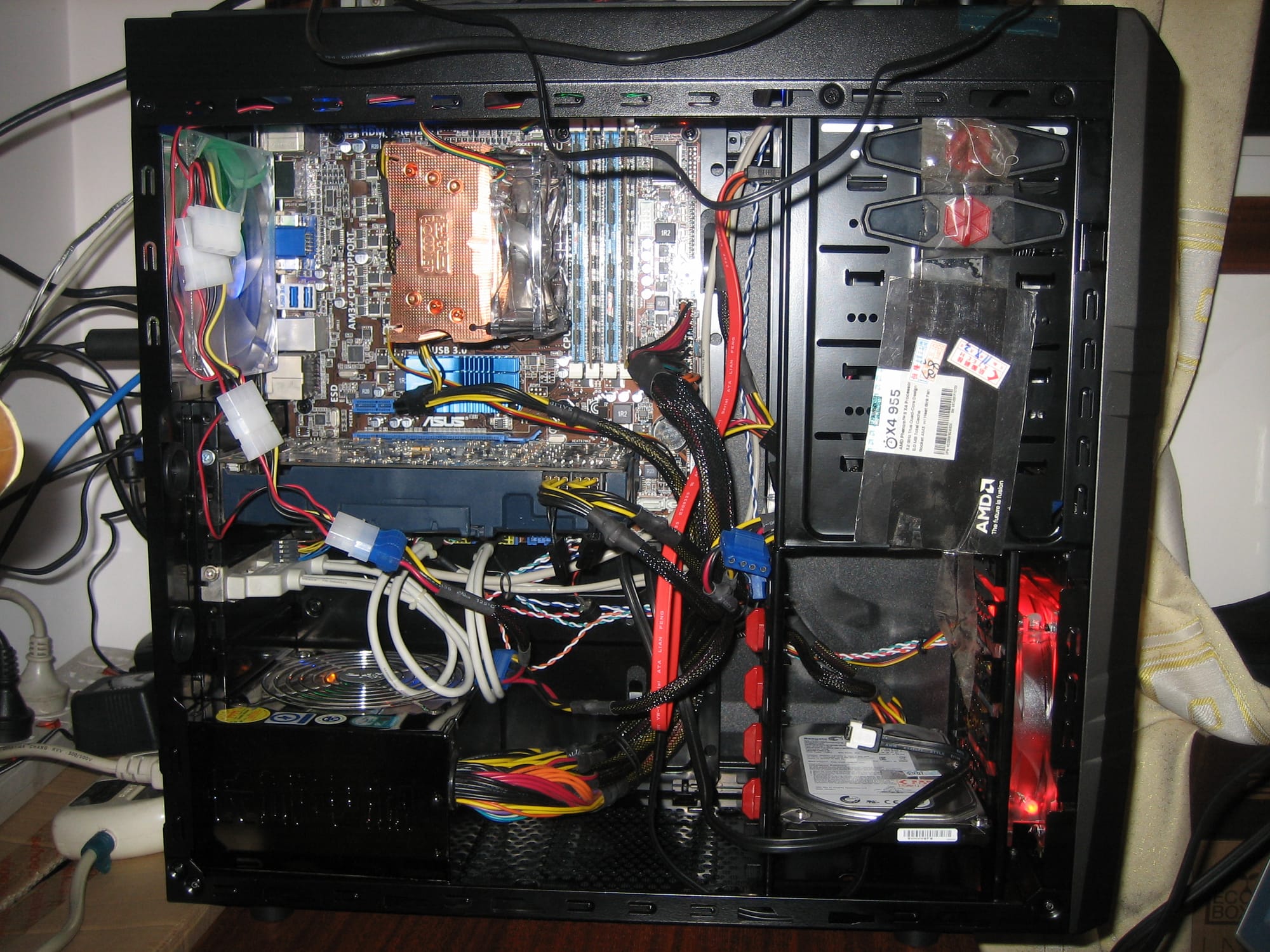 Inside of my personal computer in 2011, include PSU、hard disk driver、DVD-RW driver、Main Board、CPU cooler (Covering the CPU)、Memories and so on.
Note: some hard ware details: 
CPU: AMD Phenom II X4 955 @3.2GHz O.C. to 4.0GHz

MainBoard: ASUS M5A88 (Chipset: AMD 880G+AMD SB850)

Graphics Card: Galaxy NVIDIA GeForce GTX 460 @786MHz (CUDA cores) / 1536MHz (Shaders) with 1GiB GDDR5 Memories @4000MHz

Memory: Kingston 2GiB DDR3 @1333MHz O.C. to 1700MHz *2 and Samsung 4GiB DDR3 @1600MHz O.C. to 1700MHz *2

Hard Disk: Seagate 7200.12 500GiB 8MiB Cache 7200RPM SATA 6.0Gb/s

DVD Driver: Pionner DVD-RW SATA1.5Gb/s

CPU cooler: PCCOOLER S93E

PSU: Great Wall BTX-500SE