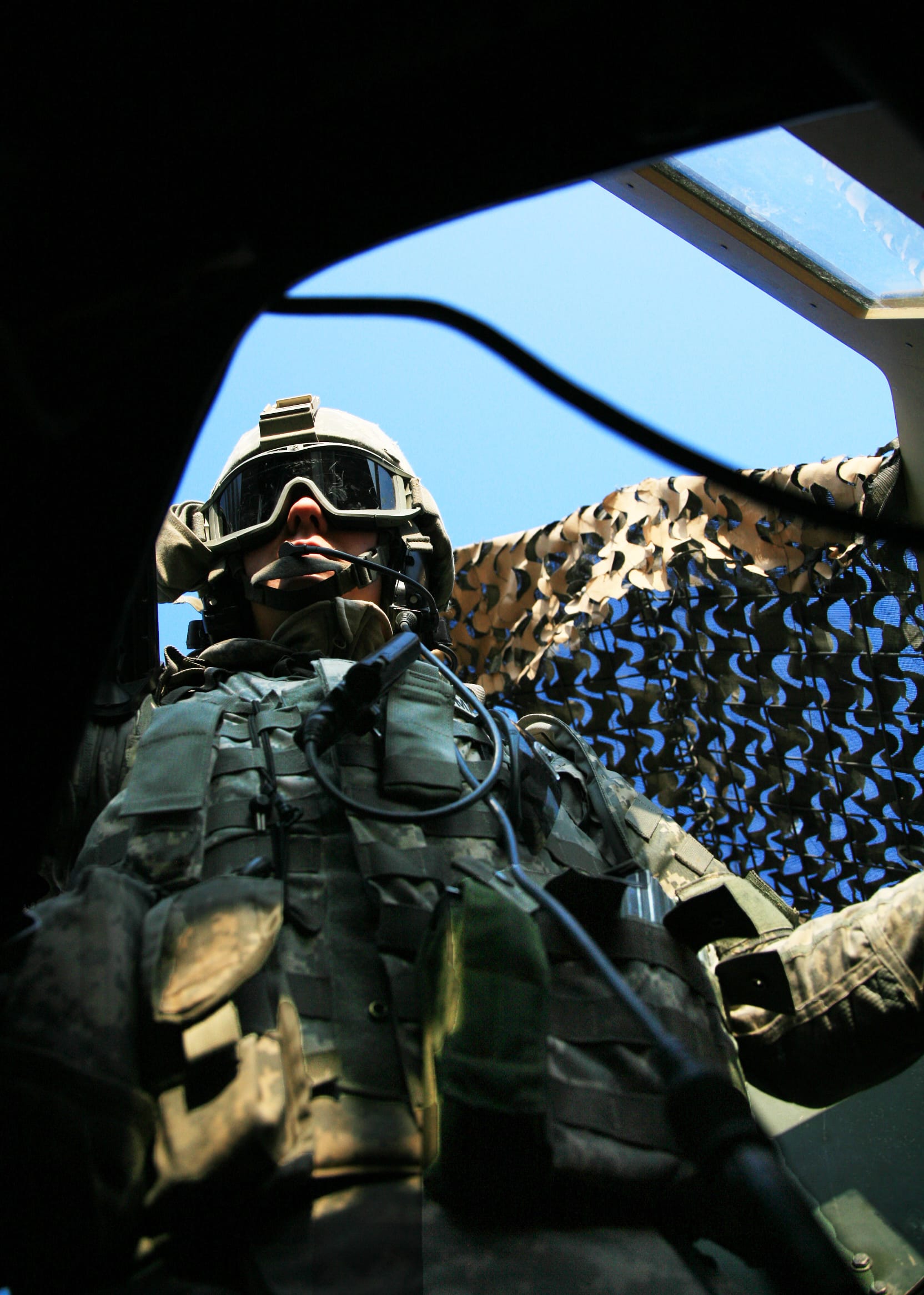 Petty Officer 229th Military Police Company, 336th MP Battalion, 49th MP Brigade, gunner, Private 1st Class Andrew Thomas pulls security for his convoy while traveling down Route Irish, Baghdad, Iraq, Dec. 9. The Virginia National Guard unit is home based in Virgina Beach, Va., and it has a primary mission of personal security detachment, or PSD.