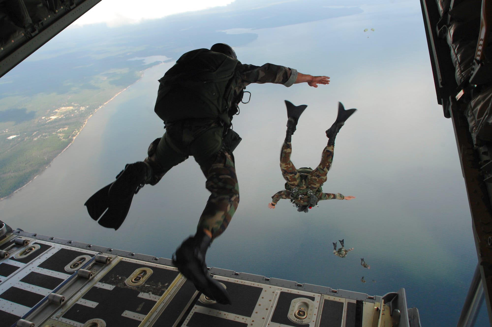 U.S. Air Force Airmen from the 720th Special Tactics Group out of Hurlburt Field, Fla., jump out of a C-130J Hercules aircraft during water rescue training above Choctawhatchee Bay, over the Destin coastline in Florida Oct. 3, 2007. The training is designed to enhance aerial ZoDIAC deployment and personnel recovery. The aircraft belongs to the 41st Airlift Squadron out of Little Rock Air Force Base in Arkansas.