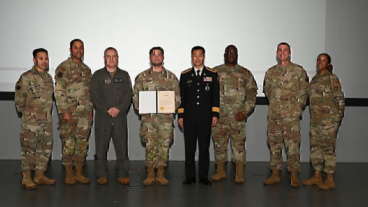 U.S. Air Force Staff Sgt. Natanael Garcia, center left, 8th Communications Squadron network system operations supervisor, stands with Yi, Jong-jun, center right, Seoul Fire Department duty director, and base leadership during a recognition ceremony at Kunsan Air Base, Republic of Korea, Sept. 27, 2024. Garcia assisted in putting out a building fire and evacuating the tenants in Seoul on Sept. 15. (U.S. Air Force photo by Staff Sgt. Nicholas Ross)