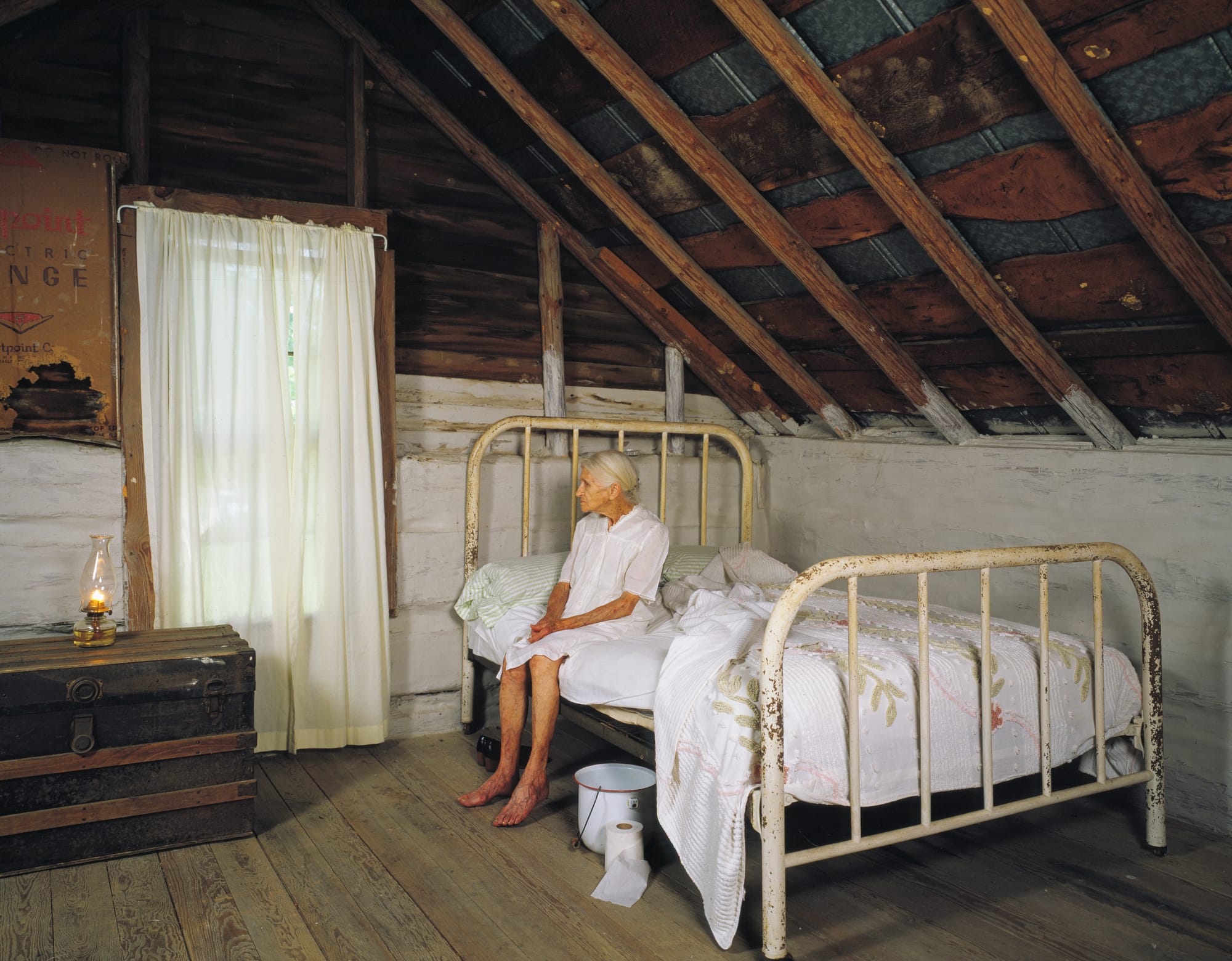 Kate Carter, on her 90th birthday, poses for photographer Carol M. Highsmith in the log cabins in North Carolina, United States, where Highsmith's great-grandfather and grandfather, Pleasant Jiles Carter (1847-1931) and Yancey Ligon Carter (1873-1947), were born and lived in Wentworth, North Carolina.