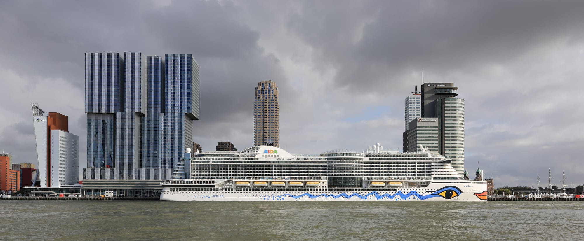 AIDAperla at Wilhelminapier in Rotterdam with the high-rises De Rotterdam and World Port Center.