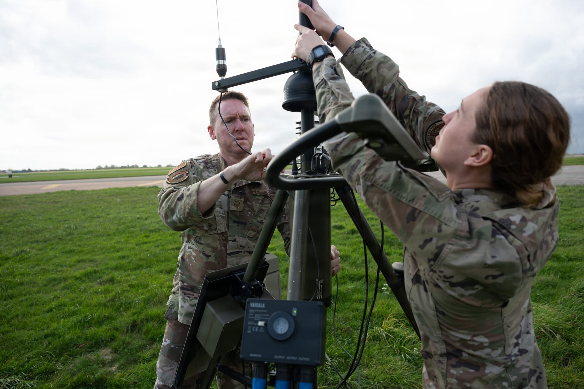 U.S. Air Force 1st Lt. Grace Kimzey, 420th Air Base Squadron Weather Flight Commander, and Master Sgt. Robert Welborn, 420th Air Base Squadron Flight Chief of Weather Operations, assembles components of the Tactical Meteorological Observing System (TMOS) at RAF Fairford, England, Nov. 4, 2025. The Weather Flight uses the TMOS to ensure uninterrupted weather coverage for airfield missions. (U.S. Air Force photo by Airman 1st Class Adam Enbal)