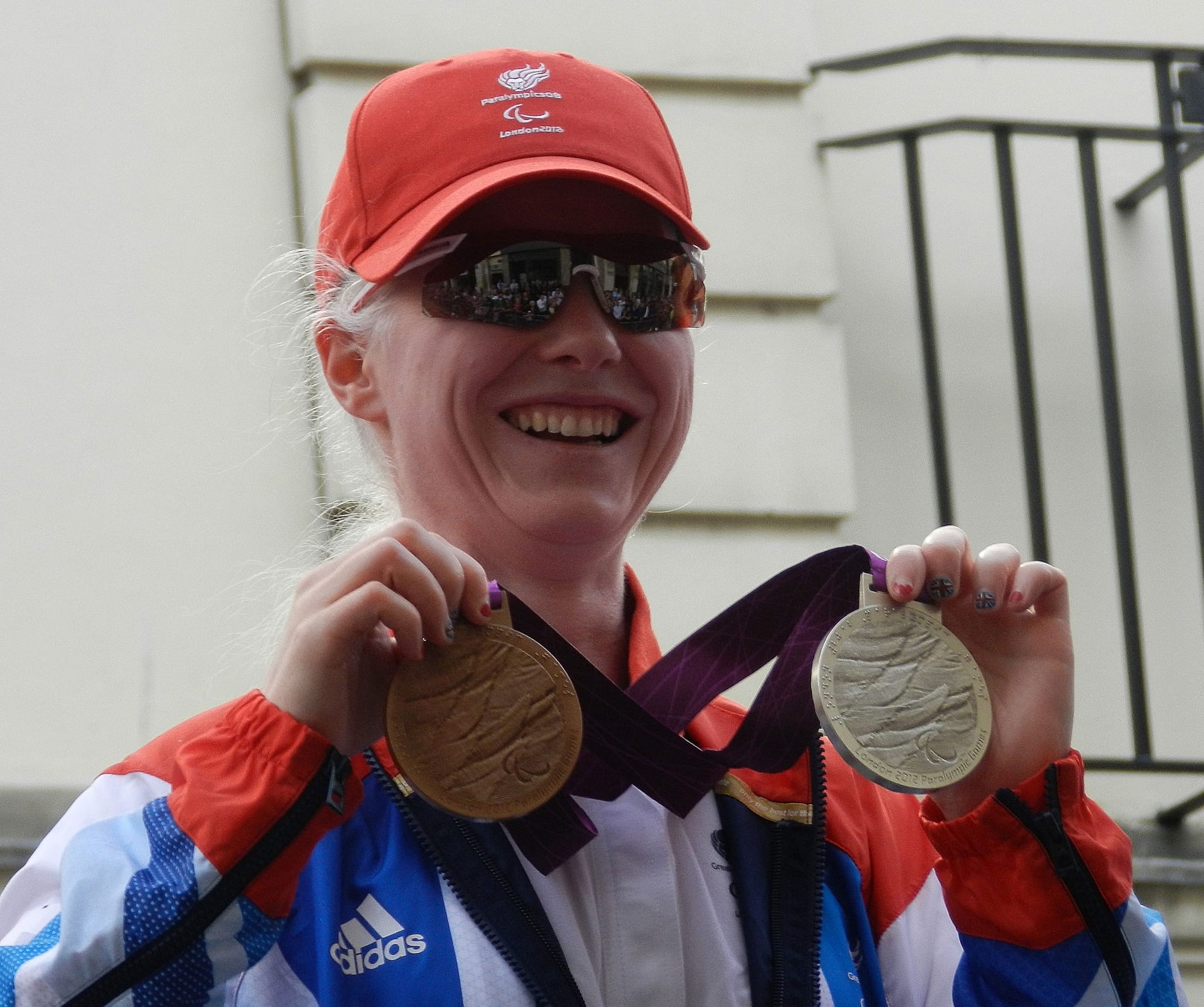 Paralympic cyclist Aileen McGlynn holding her silver and bronze medals won at the 2012 Summer Paralympic Games