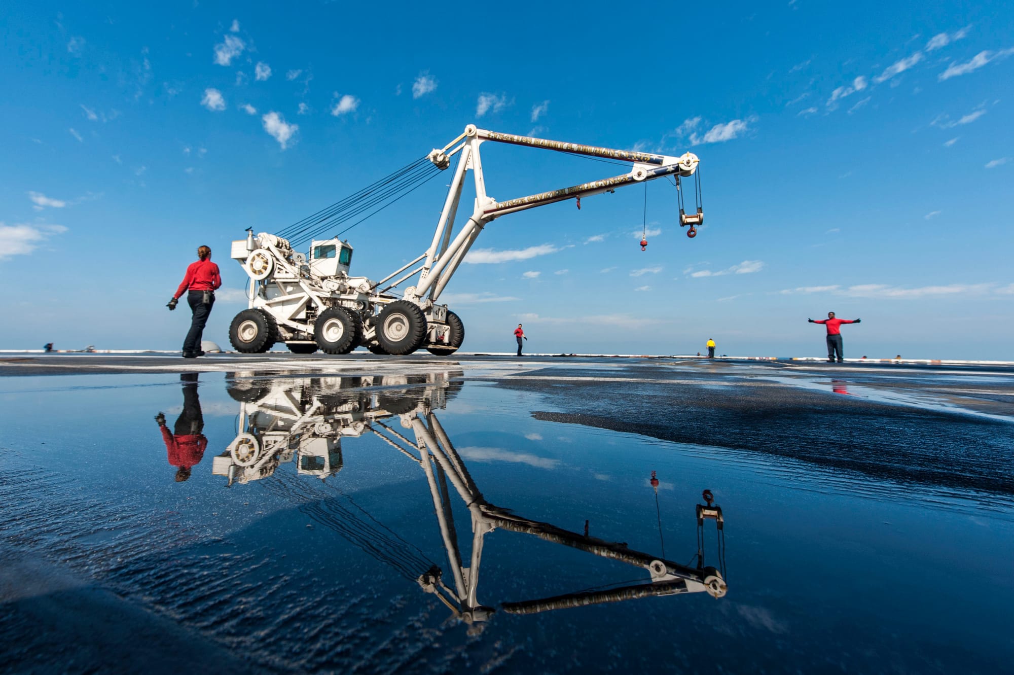 U.S. Navy sailors assigned to the crash and salvage team transport the mobile salvage crane on the flight deck of the aircraft carrier USS Harry S. Truman (CVN-75) in the Arabian Gulf. Harry S. Truman was deployed to the U.S. 5th Fleet area of responsibility.