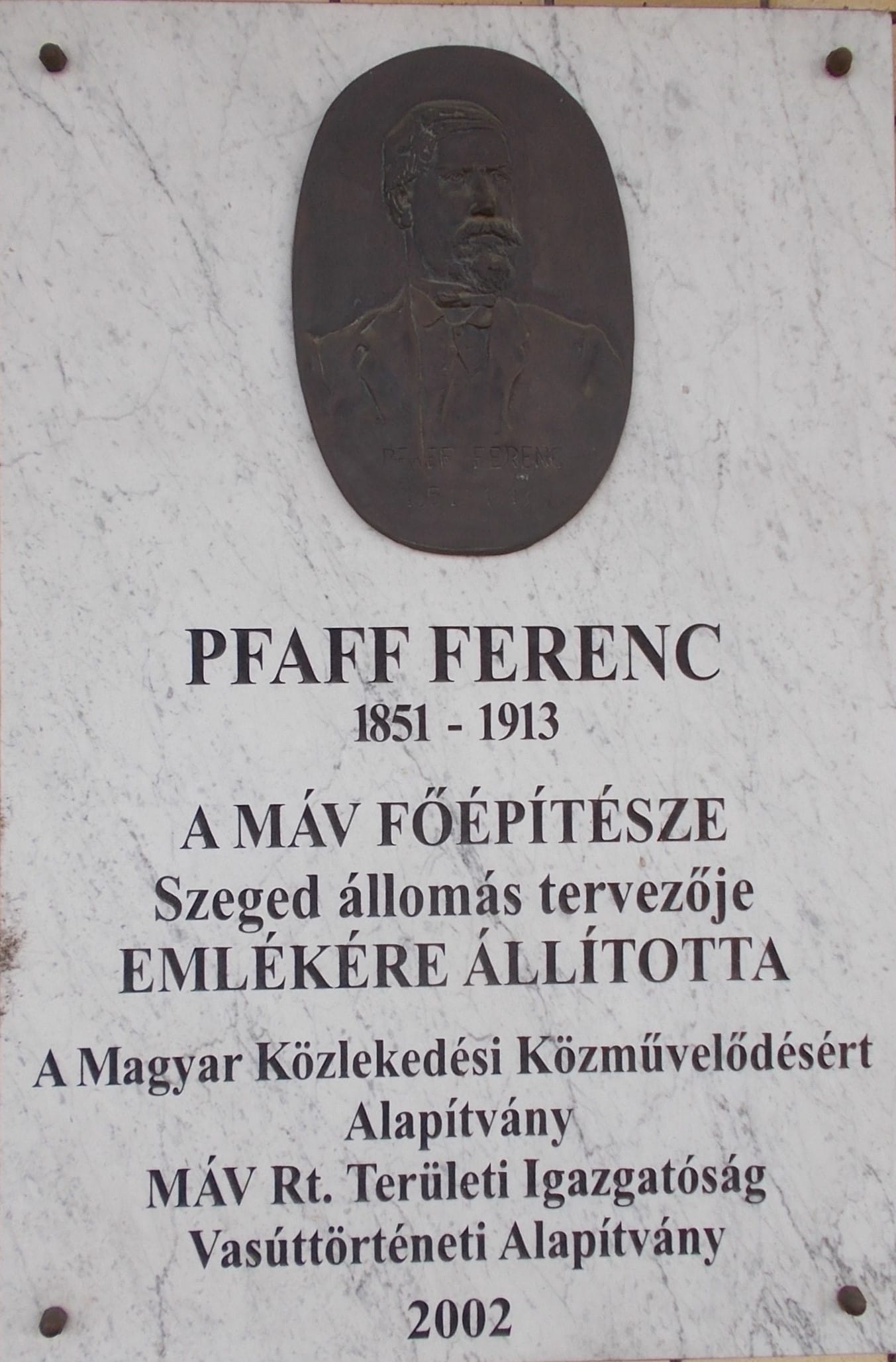 Railway station, main building. Plaques on trackside facade: ICOMOS award relief memorial plaque inscription: "For the exemplary careful restoration of the building, MÁV Zrt. won the Icomos 2008 Award awarded by the Kulturákis Heritage Office//Investor MÁV ZRt Property Management Directorate. /Designer: Hajós Architects Ltd./Contractor: Délépítő-Ornament Consortium' - Railway transport memorial plaque (installed March 4, 2004, 150th anniversary, artwork by András Lapis, bronze, limestone, 120x100 cm) inscription: Railway transport to Szeged started on March 4, 1854. Hungary railway network in 1854./Installed by the Municipality of Szeged, MÁV RT. and the Railway History Foundation - Holocaust memorial plaque (installed 2004, by Sándor Sebestyén) reads: 'Blessed is the memory of the martyrs! It was placed by the Hungarian Evangelical Fellowship and the John Wesley Pastoral Training College on the 60th anniversary of the Holocaust in 2004. The establishment of the memorial was supported by the Freight Transport Department of MÁV.' bronze relief depicts a detail of a cattle wagon. The material of the slab is black granite (50x50 cm)"On June 25, 1944, the first train left Szeged for Auschwitz. More than 3,000 Hungarian citizens classified as Jews were squeezed into the wagons. Only a few returned home from the Nazi concentration camp." - World War II, memorial plaque for the bombings in Szeged (installed December 5, 1997, creators: Mihály Fritz, (coat of arms of Szeged), András Lapis (MÁV symbol) András Tóth (symbol of civil protection)), inscription: "In memory of the victims of the bombings in Szeged during World War II and on the occasion of the 60th anniversary of the establishment of the Air Protection League //General Assembly of the City of Szeged with County Rank, Regional Directorate of MÁV Rt. Szeged, Csongrád County Civil Protection Association. Szeged, 5 December 1997." - Ferenc Pfaff memorial plaque (Erected 2002, by sculptor Kálmán Veres) inscription: Ferenc Pfaff (1851-1913)// erected in memory of the chief architect of MÁV, designer of Szeged station//Foundation for Hungarian Transport Public Education, MÁV Rt. Regional Directorate, Railway History Foundation. - II. Ferenc Rákóczi memorial plaque (Erected December 22, 1996, copy of Béla Löffler's 1938 work) Text of the plaque: Rodostó-1906-Košice//Erected by the City of Szeged and MÁV Rt. to commemorate the passage of the prince's ashes through Szeged and Kiskundorozsma.' "Košice sculptor Károly Löffler made the original relief in 1938. It is on the northern wall of Košice Cathedral, above the Rákóczi Crypt, and another copy of it is at the entrance of the Rákóczi Memorial House in Rhodošto." - Inside: Bacchant Feast oil on canvas ceiling panno. Inauguration after renovation: 2006, made: 1902, by Ödön Kacziány, On the ceiling fresco of the restaurant we can see a mythological scene, Bacchalania, in the middle a half-naked dancing Bacchantes, surrounded by figures drinking, dancing and playing music. - Indóház Square, Alsóváros (Lower Town) neighborough, Szeged, Csongrád-Csanád County, Hungary.