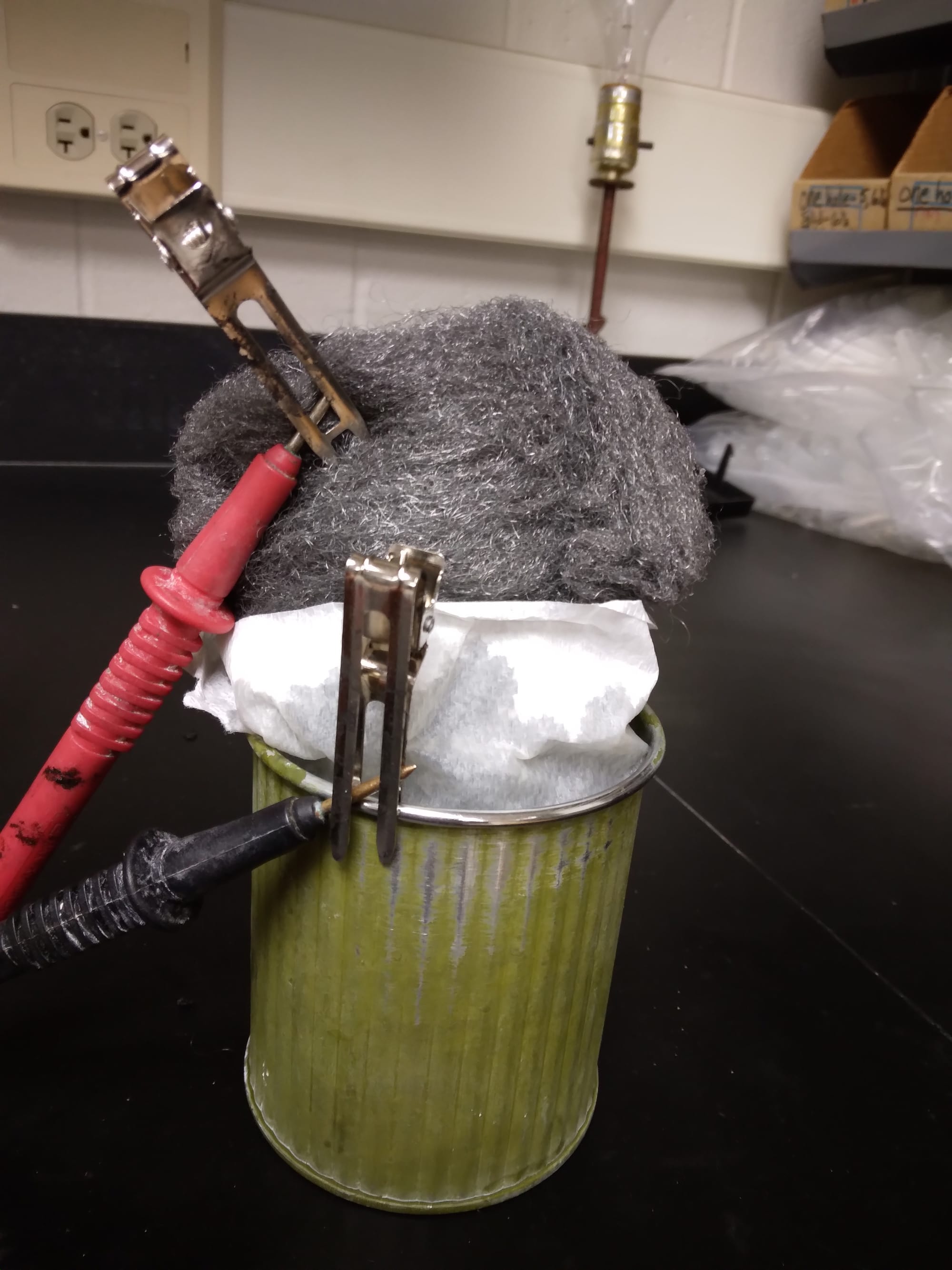 A Chinese company sells small ( 5") wax-coated zinc cans for use as flower pots. I found ethyl acetate solvent can remove the inner was coating to expose the fresh zinc metal. A steel wool ball is wrapped in paper towel and placed in the can with 20% (m/v) aq. NaOH electrolyte. 1.18V (open) and 750 mA. Shirt circuit to 0.87 V sees rapid rebound. This cell may be re-chargeable, We are collecting data on performance. Inexpensive and great for student introduction to energy storage.