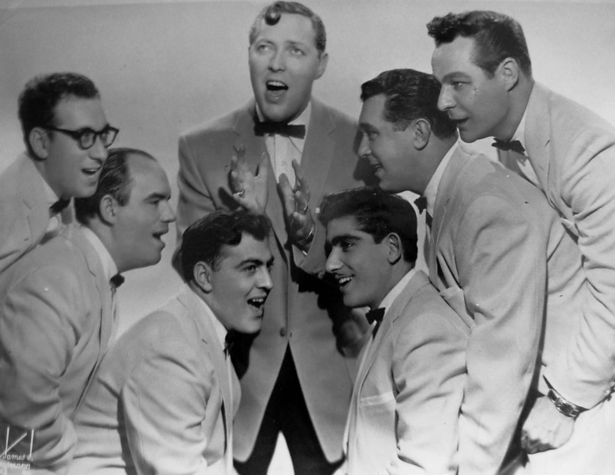 Photo of Bill Haley and his Comets.
Decca Records issued the ad without any copyright marks or notations.
The photo is a larger version of that in the Decca ad.
US Copyright Office page 3-magazines are collective works (PDF)
"A notice for the collective work will not serve as the notice for advertisements inserted on behalf of persons other than the copyright owner of the collective work. These advertisements should each bear a separate notice in the name of the copyright owner of the advertisement."

Copyright for Billboard magazine would not affect this non-marked Decca Records ad. Decca didn't label their ad as under copyright.