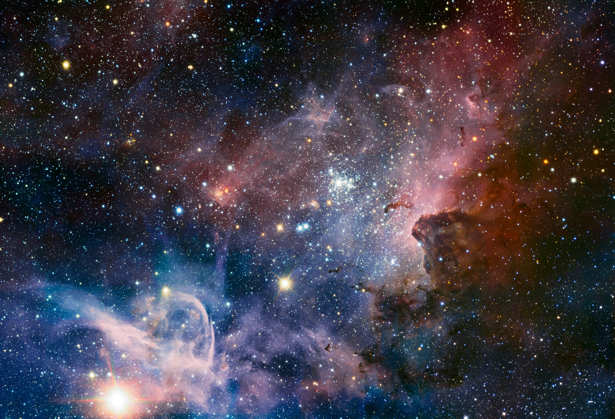 This broad panorama of the Carina Nebula, a region of massive star formation in the southern skies, was taken in infrared light using the HAWK-I camera on ESO’s Very Large Telescope. Many previously hidden features, scattered across a spectacular celestial landscape of gas, dust and young stars, have emerged. Some of these features have been annotated in Commons. Trumpler&nbsp;16 (annotated) is an open cluster that contains the luminous, massive blue variable Eta&nbsp;Carinae, one of the brightest stars in the galaxy, possibly as much as 120 times the mass of the Sun, and emitting the light of 4,000,000 Suns. Eta&nbsp;Carinae is nearing the end of its life, and is surrounded by a huge nebula, cast off by numerous eruptions of the star over the last several centuries; it is expected to explode into a supernova at any time. Trumpler&nbsp;14 (annotated) contains the huge double star HD&nbsp;93129&nbsp;A/B. The young O3 class star HD&nbsp;93129&nbsp;A is one of the brightest stars in the galaxy that is still on the main sequence, and with a luminosity equivalent to 3,000,000 Suns, is very nearly as bright as Eta&nbsp;Carinae, but this is not obvious in the photo due to obscuring nebulosities.