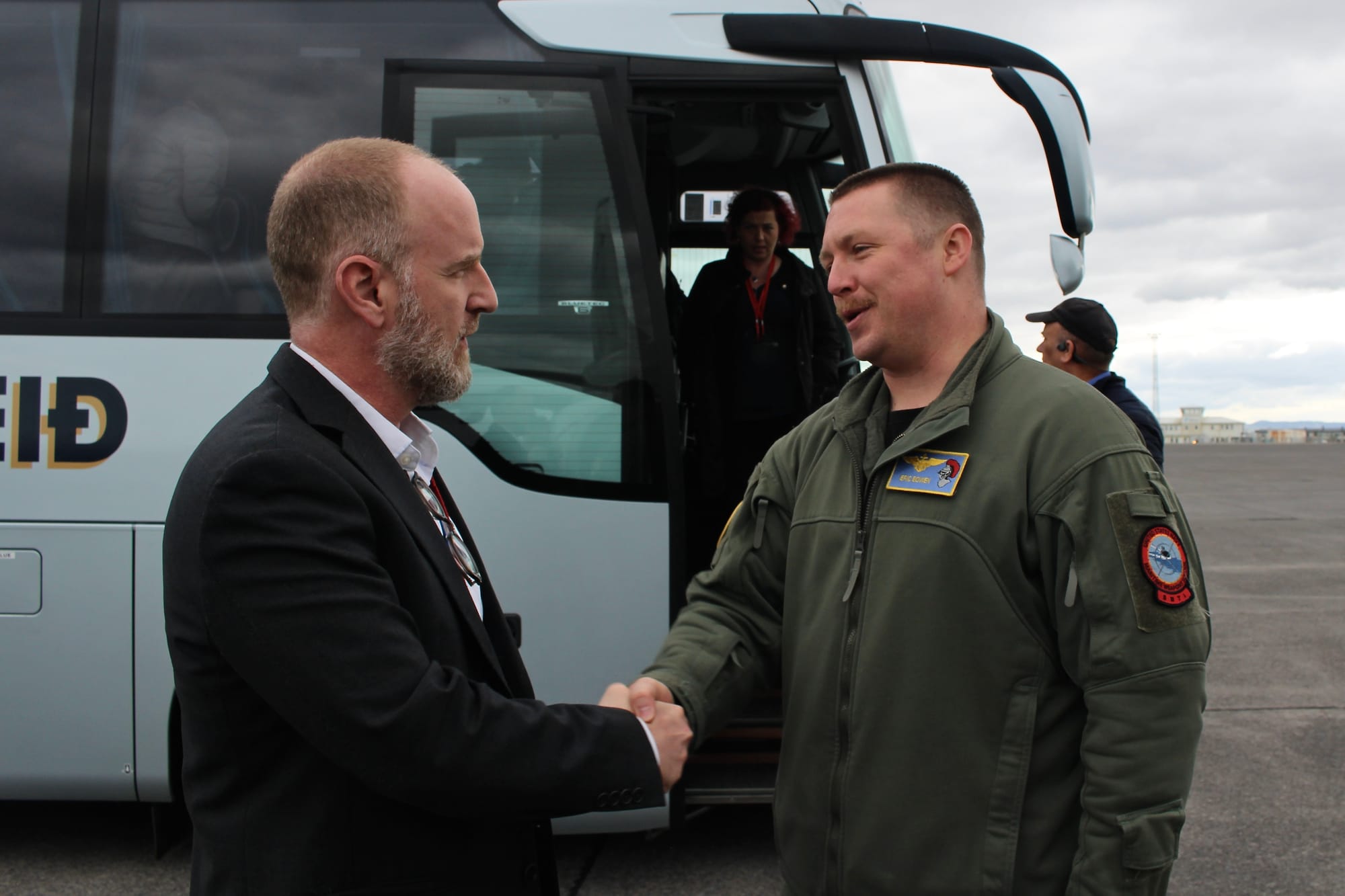 KEFLAVÍK, Iceland (July 4, 2025) - Cmdr. Eric Bowen, commanding officer, Patrol Squadron (VP) 46, shakes hands with Ethan Corbin, Director, Defense and Security Committee, NATO Parliamentary Assembly, during a tour at Keflavík Air Base, Iceland, July 4, 2025. VP-46 and VP-69 are on a joint deployment in the U.S. 6th Fleet area of operations to support warfighting effectiveness, lethality and readiness of U.S. Naval Forces Europe-Africa, and defend U.S., Allied and partner interests in the region. (U.S. Navy photo by Lt. Sara Wedemeyer)
