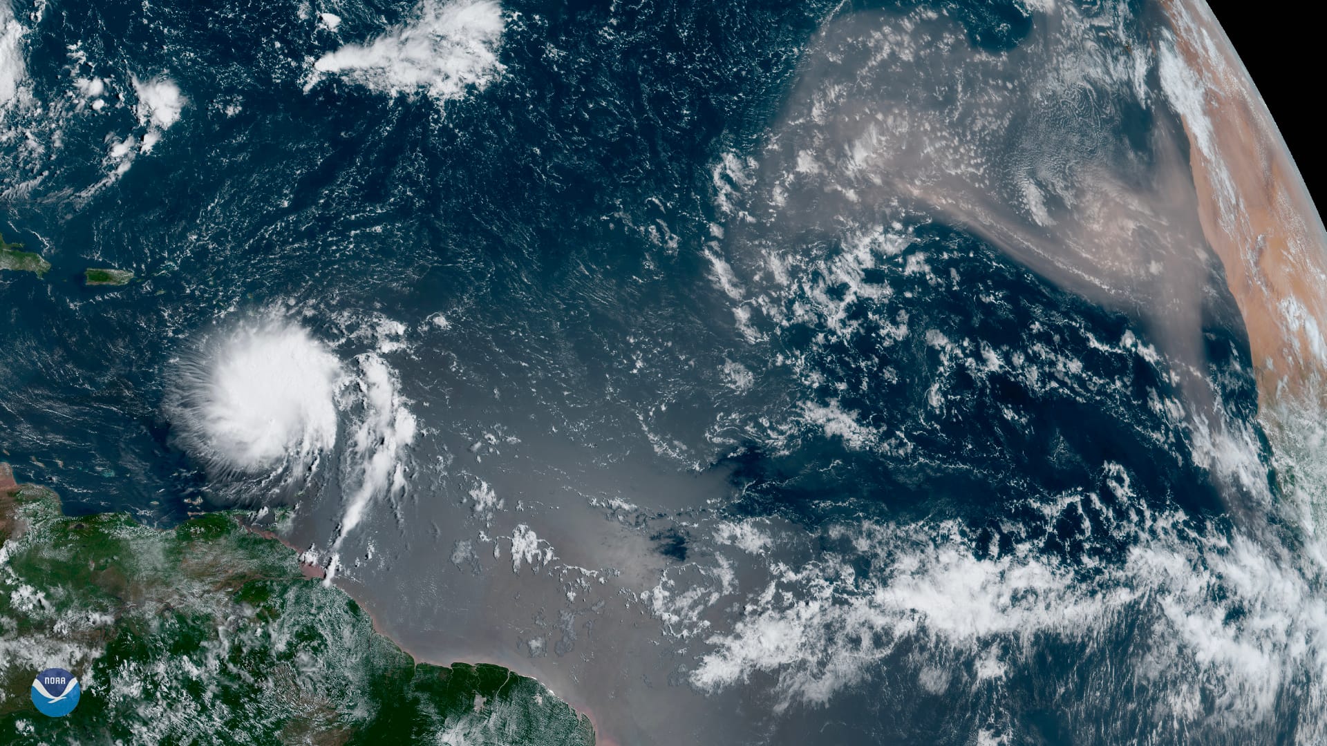 Although we’re inching closer to the peak of hurricane season — which typically occurs in early September — GOES East spotted one of the largest plumes of Saharan dust this year blowing across the Atlantic Ocean on Tuesday, Aug. 27, 2019, as Tropical Storm Dorian passed over the Lesser Antilles. All that dust helps create a stable layer of dry, sinking air, which can help prevent tropical disturbances from spinning or gaining strength. While this could play a key role in suppressing future storms, Tropical Storm Dorian is up against dry air, which is disrupting the circulation of its inner core. 
Dorian, which is forecast to move across the eastern and northeastern Caribbean Sea over the next few days, will have to battle terrain in order to reach hurricane strength. The slowly strengthening storm is forecast to take a turn toward the northwest on Wednesday, reaching near-hurricane strength as it moves close to Puerto Rico and eastern Hispaniola. According to the National Hurricane Center, the storm could threaten the Bahamas and Florida this weekend. 
The GOES East geostationary satellite, also known as GOES-16, keeps watch over most of North America, including the continental United States and Mexico, as well as Central and South America, the Caribbean, and the Atlantic Ocean to the west coast of Africa. The satellite's high-resolution imagery provides optimal viewing of severe weather events, including thunderstorms, tropical storms, and hurricanes.

<a href="https://www.nesdis.noaa.gov/content/large-saharan-dust-plume-blows-across-atlantic" rel="noreferrer nofollow">www.nesdis.noaa.gov/content/large-saharan-dust-plume-blow...</a>