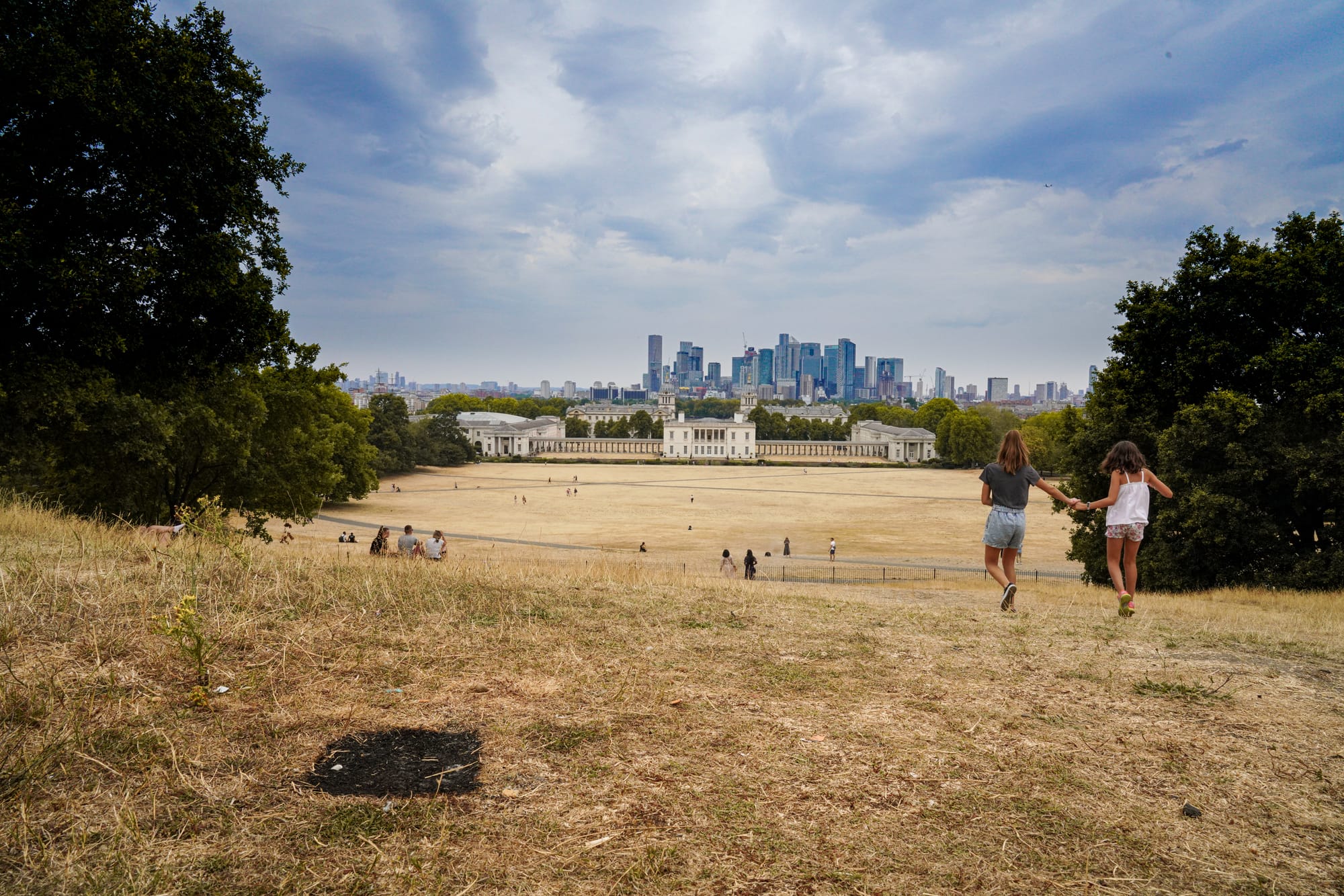 At the end of a long heat wave, and with the grass and much of the vegetation tinder dry, the ground has been clearly blackened by a seemingly recent barbecue or small fire. Unfortunately, I don't know who was responsible for it.
Greenwich Park is just a short bus ride from where I live in London. It was not just the bleached grass that was shocking - many of the trees were already losing their leaves and younger trees looked seriously stressed. London and much of Europe have seen many weeks of extreme heat and drought.
The mainstream media reprimands individuals for wasting water, justifiably exhorting us to limit our showers, but all the while ignoring the highly profitable water companies which fail to invest in infrastructure, reservoirs or leakage prevention. The media also overlooks the devastating impact of large scale agribusiness, particularly livestock farming, which places an increasingly unsustainable demand on the planet's scarce water resources, as well as further inflating emissions and driving deforestation.
Meanwhile, corporate greed is accelerating the consumption of fossil fuels and water and turbocharging climate change. We need rain. We need more regulation. More action. We need to get to net zero asap and water management should not be in private hands. Water companies are siphoning off enormous profits from a vital public utility and failing to invest anything like what is needed.
The head of Thames Water (the same company which dumped raw sewage into rivers over 5000 times in 2021) is set to pocket £3 million as a 'golden hello' for signing on as CEO ,while in total the UK's water companies have handed an average of around £2 billion every year to their shareholders in dividends since they were privatised. If they were nationalised, those profits could instead have been invested to upgrade the infrastructure and mitigate the impact of climate change and have even provided extra funds to promote sustainable alternative energy sources.
www.theguardian.com/environment/2022/apr/20/thames-water-...
www.theguardian.com/environment/2020/jul/01/england-priva...
As Caroline Lucas writes in the Guardian (12.08.22) - ' (Drought) is a consequence of years of inaction on the climate emergency. This is producing a perfect storm of energy insecurity, food supply chaos and extreme weather that is wreaking havoc on society.'
www.theguardian.com/commentisfree/2022/aug/12/drought-uk-...