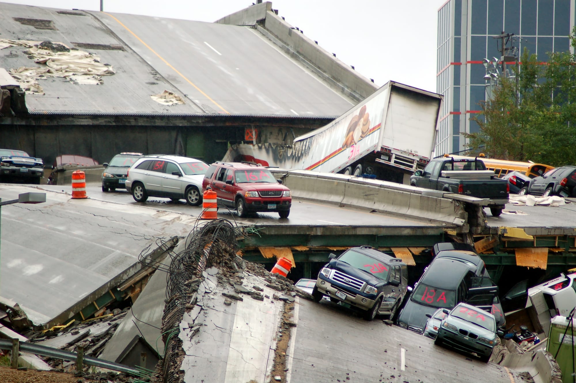 Cars rest on the collapsed portion of I-35W Mississippi River bridge, after the August 1st, 2007 collapse. This was featured as one of the 12 most powerful photos of 2007 on ABC News online.[1]