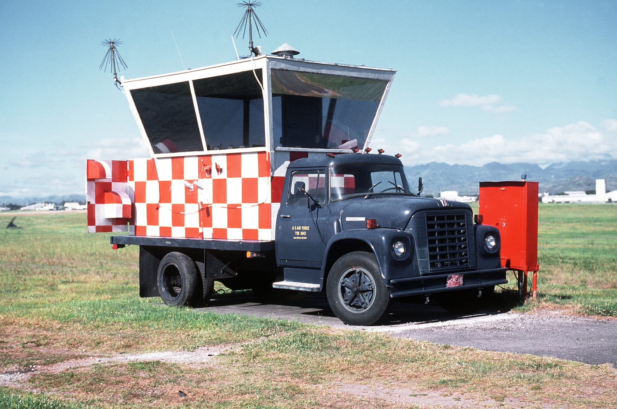 A mobile unit (1977 International Harvester Loadstar) serves as an observation post for a ground crew member who monitors aircraft preparing to depart from the runway during exercise COPE THUNDER 89-5.
