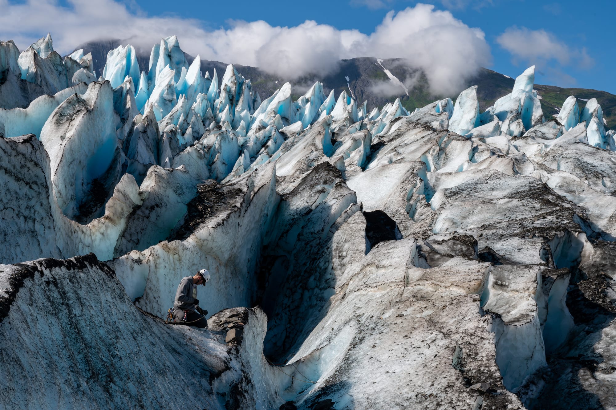 U.S. Air Force Airman 1st Class Wynn Quinton, food service apprentice, 673rd Force Support Squadron, and Operation Colony Glacier recovery team member, checks ice anchors for teammates searching through debris inside a crevasse at Colony Glacier, Alaska, July 31, 2024. Operation Colony Glacier is an effort to recover the remains of service members and wreckage from a C-124 Globemaster II that crashed in November 1952 with 52 military members on board. As of May 2024, 47 of the 52 service members have been identified. The recovery effort has taken place every summer since 2012 by personnel from Alaskan Command, 11th Airborne Division, Alaska National Guard, Air Force Mortuary Affairs Operations, Armed Forces Medical Examiner System (AFMES), U.S. Army Alaska, 673rd Air Base Wing, 3rd Wing and Detachment 1, 66th Training Squadron. (U.S. Air Force photo by Tech. Sgt. Don Hudson)