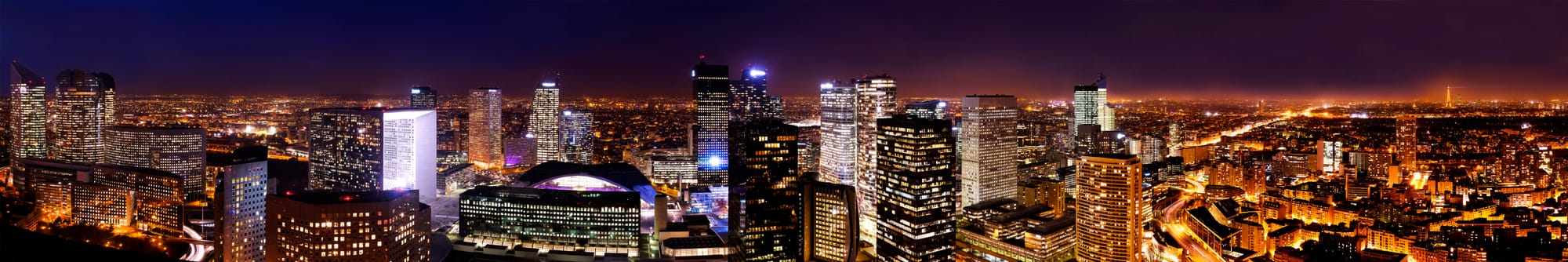 Paris business district of La Défense (cities of Puteaux, Courbevoie and Nanterre) as seen from the tour Défense 2000. The historical axis joins the Arc de Triomphe du Carrousel to the Grande Arche de la Fraternité passing by the Arc de Triomphe de l'Étoile.