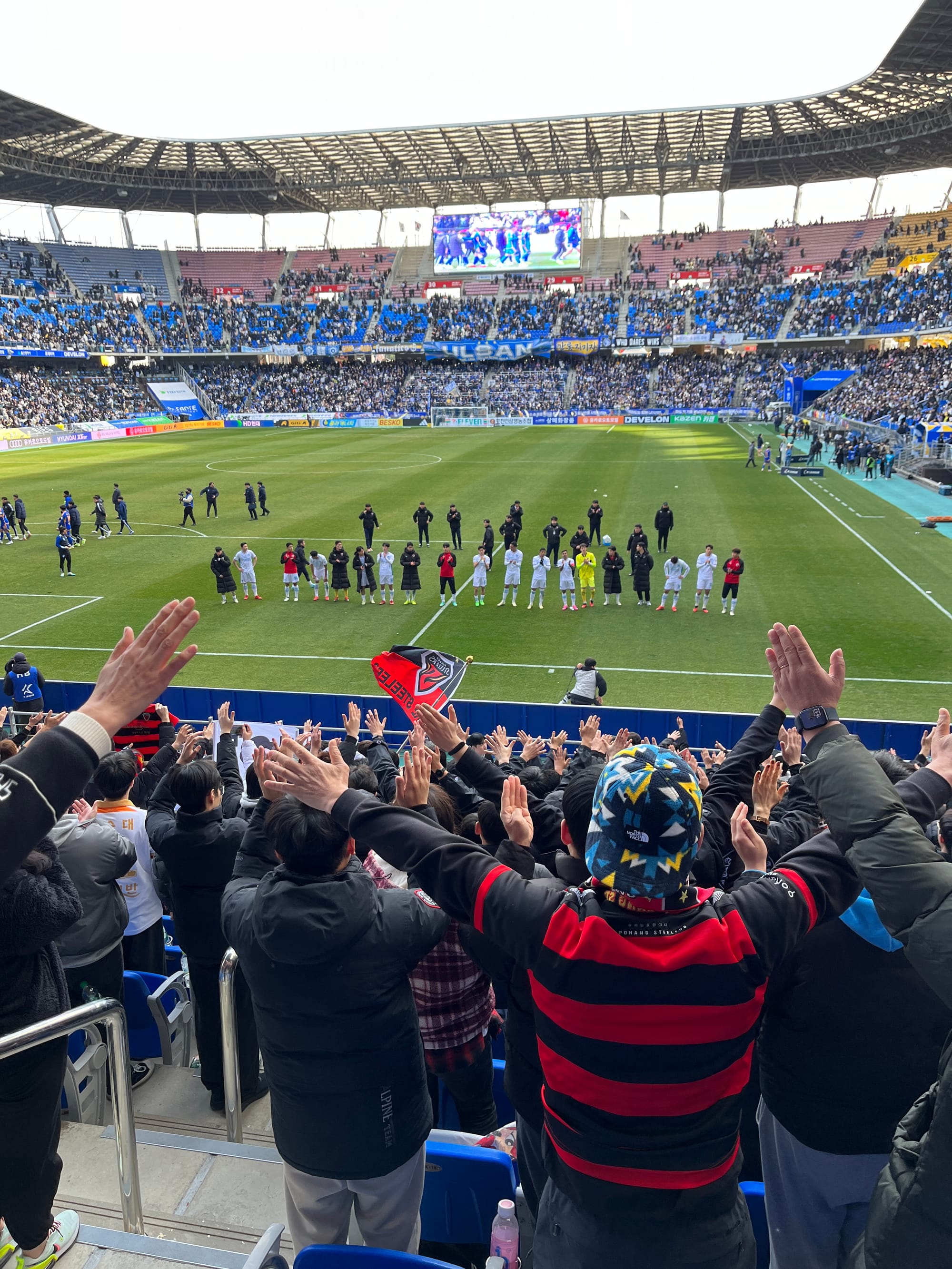 Fans of Pohang Steelers cheer their team following an away defeat to Ulsan HD