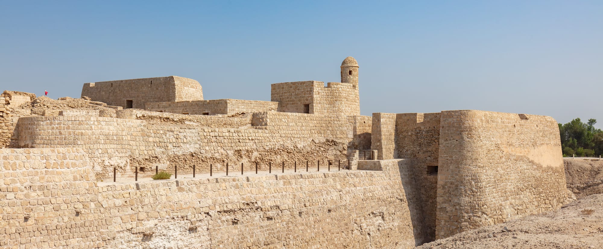 Qal'at al-Bahrain, Karbabad, Bahrain. The archaeological site, also known as the “Fort of Bahrain”, was the capital of the Dilmun civilization and a place of consistent human settlement and occupation from c. 2300 BC to the present. A Portuguese fort stands today atop the site and it became a UNESCO World Heritage Site in 2005.