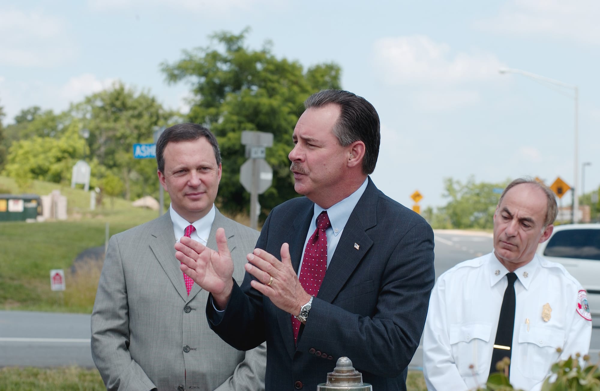 Ashburn, Va., June 21, 2005 -- US Fire Administrator R. David Paulison (fg) speaks to firefighters while Under Secretary Michael D. Brown (bg) looks on and the International Assoc. of Fire Chiefs President Robert DiPoli (right) listens during a ceremony honoring firefighters on National Stand Down Day for Firefighter Safety and Health at Loudoun County Fire Rescue Ashburn 6 station.