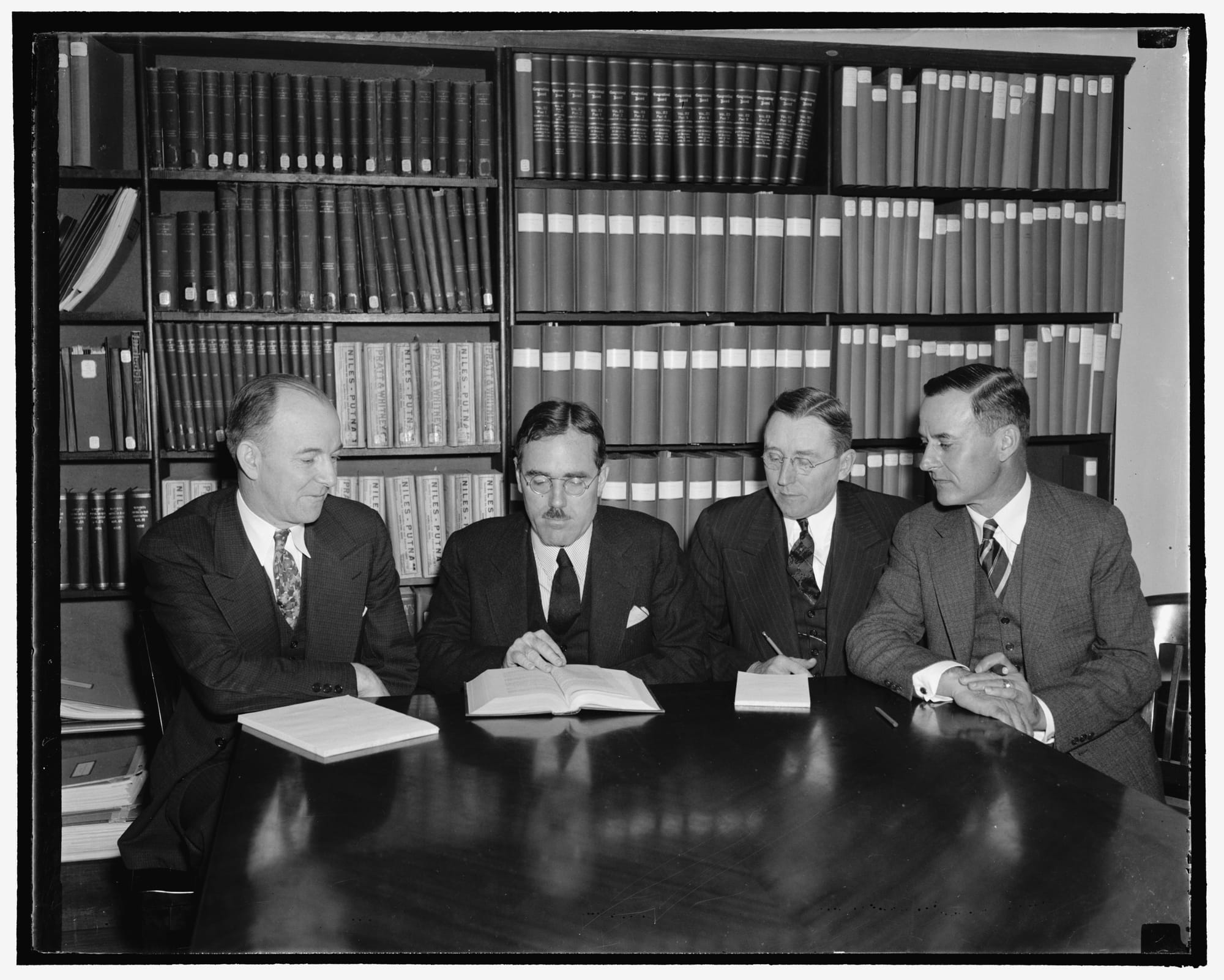 Title: Railroad Retirement Board is now constituted. Washington, D.C., Oct. 3. The Railroad Retirement Board at its meeting today welcomes M.R. Reed, new member of the board appointed by President Roosevelt, and James Gordon Robinson, newly chosen Head of the Railroad Unemployment Insurance Bureau. Mr. Reed will represent the carriers on the board while Mr. Robinson was chosen for the Directorship of Unemployment Insurance from the open competitive examination conducted by the United States Civil Service Commission, the first ever held for a ten thousand dollar a year administrative position. Pictured, left to right: James G. Robinson, Murray W. Latimer, Chairman; Lee M. Eddy. and M.R. Reed, 10/3/38
Abstract/medium: 1 negative&nbsp;: glass&nbsp;; 4 x 5 in. or smaller