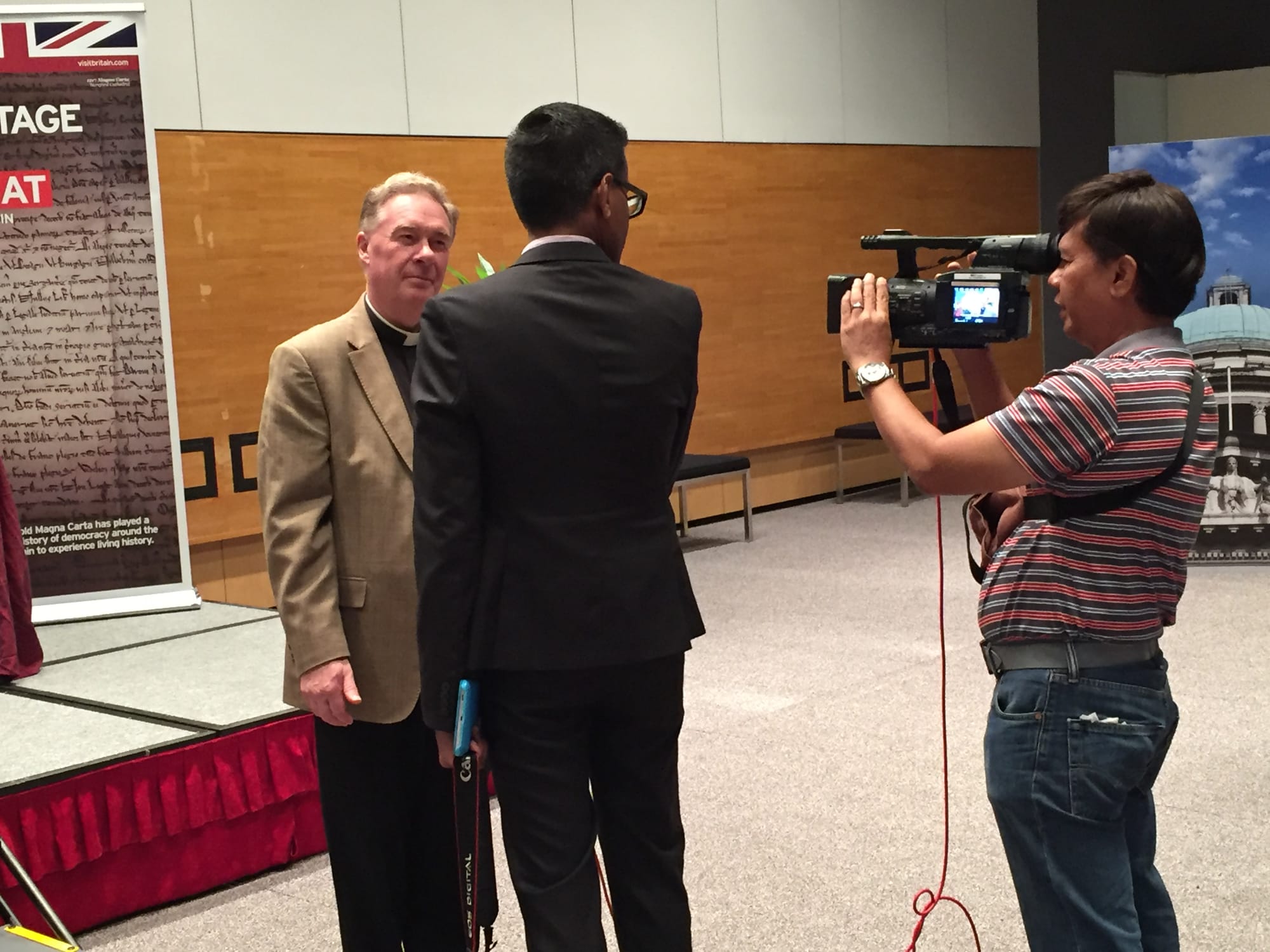 The Reverend Canon Chris Pullin, the Chancellor of Hereford Cathedral, being interviewed by the media at the Supreme Court of Singapore, where a 1217 version of Magna Carta from the Cathedral was exhibited from 19 to 23 November 2015 in an exhibition entitled 800 Years of Magna Carta.