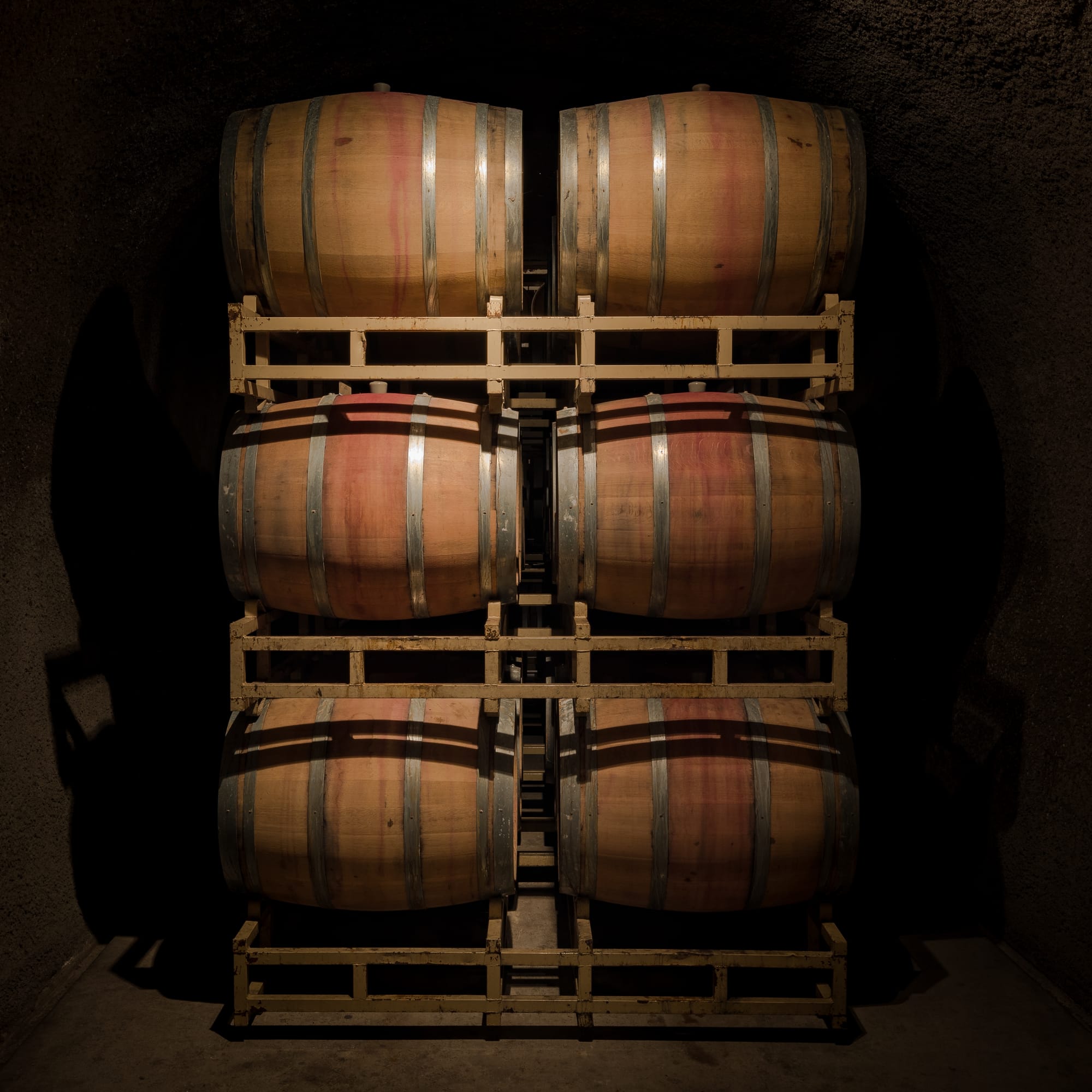 Oak barrels in the wine cave of Rutherford Hill Winery in Napa County, California. The “red band” on some wine barrels is the residue of spilt red wine.