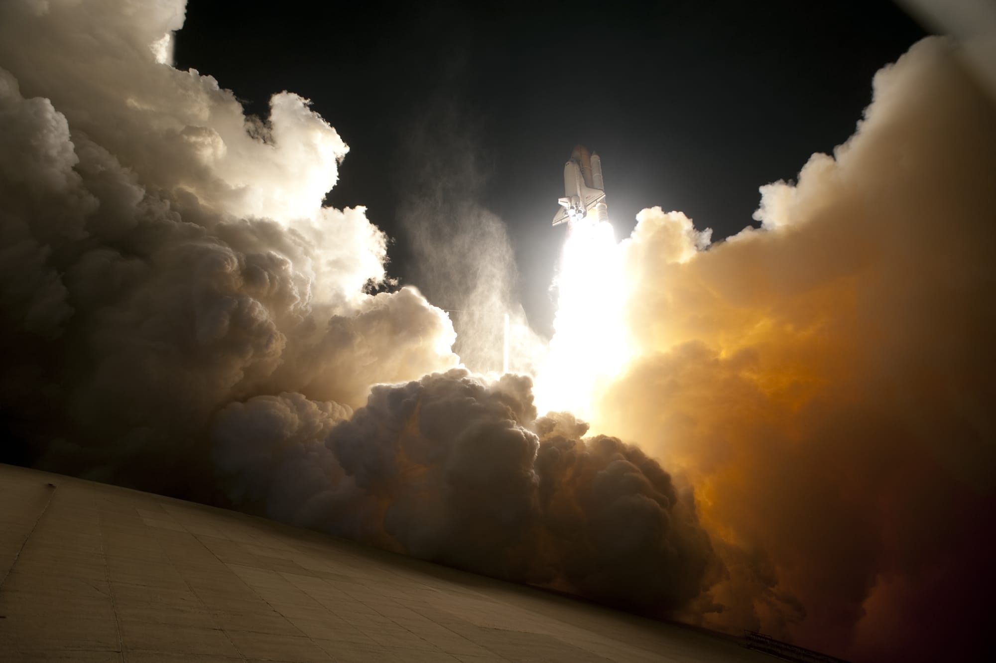 An exhaust cloud engulfs Launch Pad 39A at NASA's Kennedy Space Centre in Florida as space shuttle Endeavour lifts off into the night sky. The primary payload for the STS-130 mission to the International Space Station is the Tranquility node, a pressurized module that will provide additional room for crew members and many of the station's life support and environmental control systems. Attached to one end of Tranquility is a cupola, a unique work area with six windows on its sides and one on top. The cupola resembles a circular bay window and will provide a vastly improved view of the station's exterior. The multi-directional view will allow the crew to monitor space-walks and docking operations, as well as provide a spectacular view of Earth and other celestial objects. The module was built in Turin, Italy, by Thales Alenia Space for the European Space Agency.