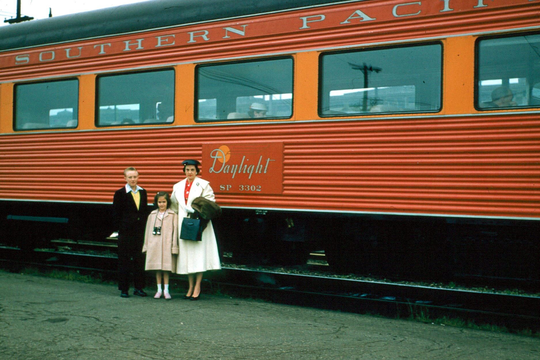 Coast Daylight Coach of the Southern Pacific Railroad, which ran between Los Angeles and San Francisco, California, USA.  Photo taken in 1956 from contributor's personal collection.  Individuals in photo are members of the family of I. Frank Tullis.