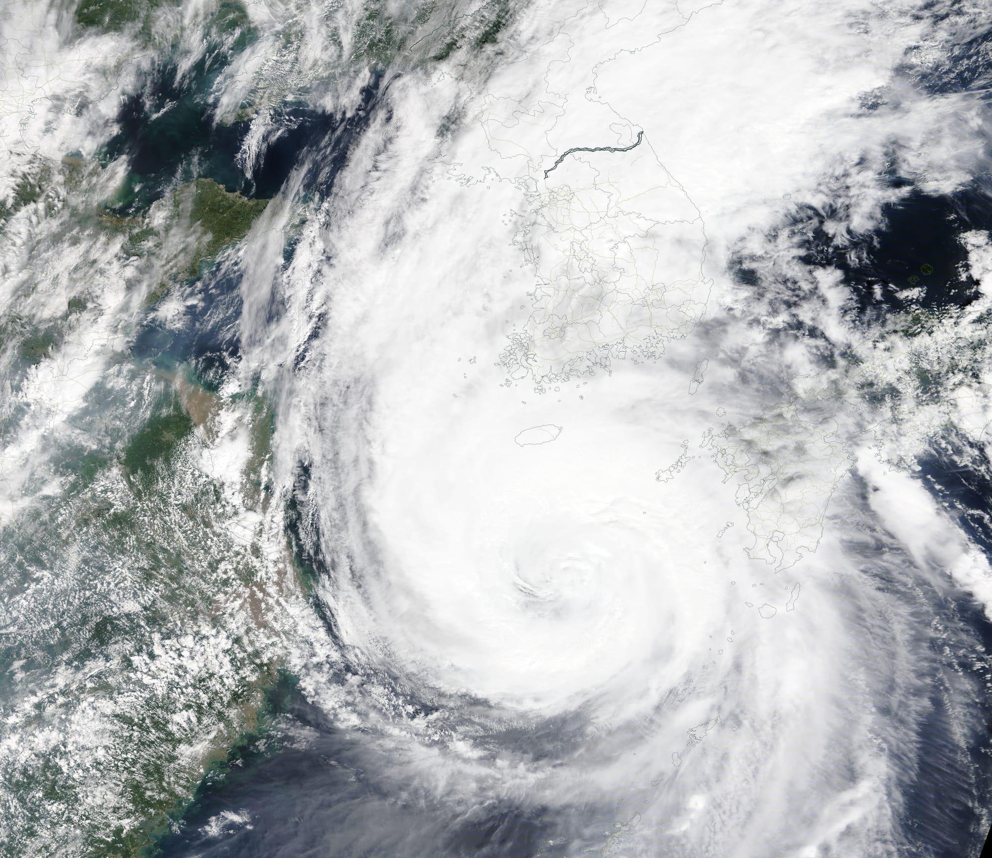 A peninsula that typically sees one typhoon per year might face three landfalling storms in two weeks. One week after Typhoon Bavi brought fierce winds and rain to North and South Korea, Typhoon Maysak plowed into South Korea as a Category 2 storm.
The Moderate Resolution Imaging Spectroradiometer (MODIS) on NASA’s Terra satellite acquired this true-color image of Maysak in the late morning on September 2, 2020. At the time, the storm had sustained winds of roughly 190 kilometers (120 miles) per hour.
Shortly before landfall, in the early hours of September 3 local time, the U.S. Joint Typhoon Warning Center (JTWC) reported sustained winds of 170 kilometers (105 miles) per hour as the eye of the storm was southwest of Busan, South Korea’s second-largest city and the world’s fifth-largest port. It is believed to be just the sixth typhoon of Category 2 strength or higher to hit the Korean Peninsula since 1951.
Maysak reached typhoon strength on August 29 and intensified to become the strongest typhoon so far in the 2020 Western Pacific season. At peak intensity on September 1, Maysak’s winds measured 230 kilometers (145 miles) per hour, a Category 4 storm. The typhoon battered Okinawa, the Ryukyu Islands, and Jeju Island before moving ashore on the Korean Peninsula. Forecasters called for widespread rainfall of 100 to 200 millimeters (4 to 8 inches). That rain will fall upon ground that has been soaked by South Korea’s second-wettest monsoon season on record and by rains from Typhoon Bevi.
The JTWC published its last advisory on Typhoon Maysak on September 2 at 1800 UTC (2:00 p.m. EDT or September 3, 3:00 a.m. Korean Standard Time). At that time the center of Maysak was located inland and about 27.6 miles (44.4 km) north-northwest of Busan. It was carrying maximum sustained winds of about 86 mph (138.4 km/h). The system was undergoing extra-tropical transition and was forecast to weaken rapidly. The system will pass over North Korea and Manchuria while the JTWC closely monitors for any signs of regeneration.

The storm troubles may not be over for North and South Korea. Another typhoon, Haishen, has been developing south of Japan, and several potential storm tracks have it making landfall on the Korean Peninsula on September 6 or 7. As of the evening of September 2, Haishen had sustained winds of 130 kilometers (80 miles) per hour, with predictions that it could strengthen to category 4 strength while moving over the extremely warm water of the tropical Western Pacific.