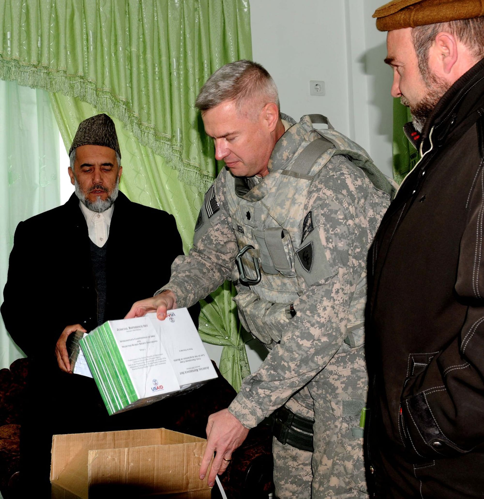 PARWAN PROVINCE, Afghanistan – U.S. Army Lt. Col. James M. Zieba, staff judge advocate for Task Force Cyclone, presented legal reference books to Chief Prosecutor of the Abdul Basheer Yaqobi, Parwan province, inside a newly built detention facility in Charikar city, Parwan province, Afghanistan, Feb. 16. Part of the visit was to schedule legal training for judges and prosecutors. “From the top all the way down the directive is to be cognizant of the culture and the people,” said Zieba, a Carmel, Ind. native who is deployed with the Indiana National Guard 38th Infantry Division. (Photo by U.S. Army Staff Sgt. Donald L. Reeves, Task Force Cyclone, 300th Mobile Public Affairs Detachment)