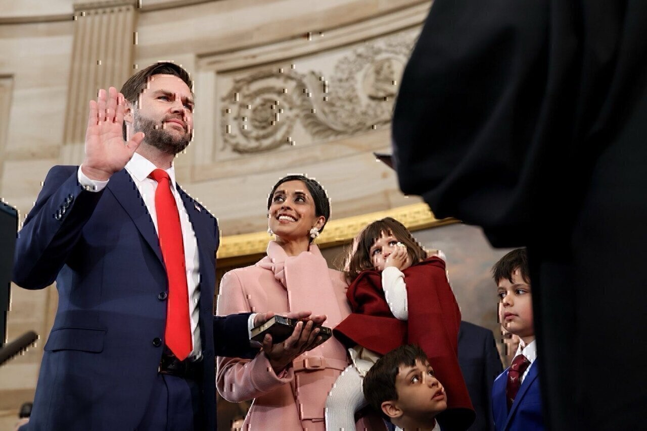 Usha Vance published this photography on Twitter, showing her husband during the oath of office as the 50th Vice President of the United States, and herself holding the Book for him with their three children watching the ceremony.
