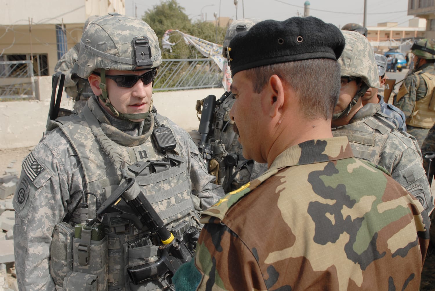 Capt. Andy Rohrer, commander, Troop B, 5th Squadron, 73rd Cavalry Regiment, 3rd Brigade Combat Team, 82nd Airborne Division, talks with an Iraqi army officer, Feb. 26, about a recently detonated improvised explosive device on in central Baghdad. Rohrer, a native of Grand Rapids, Mich., and his troops support their Iraqi security force partners through joint operations.