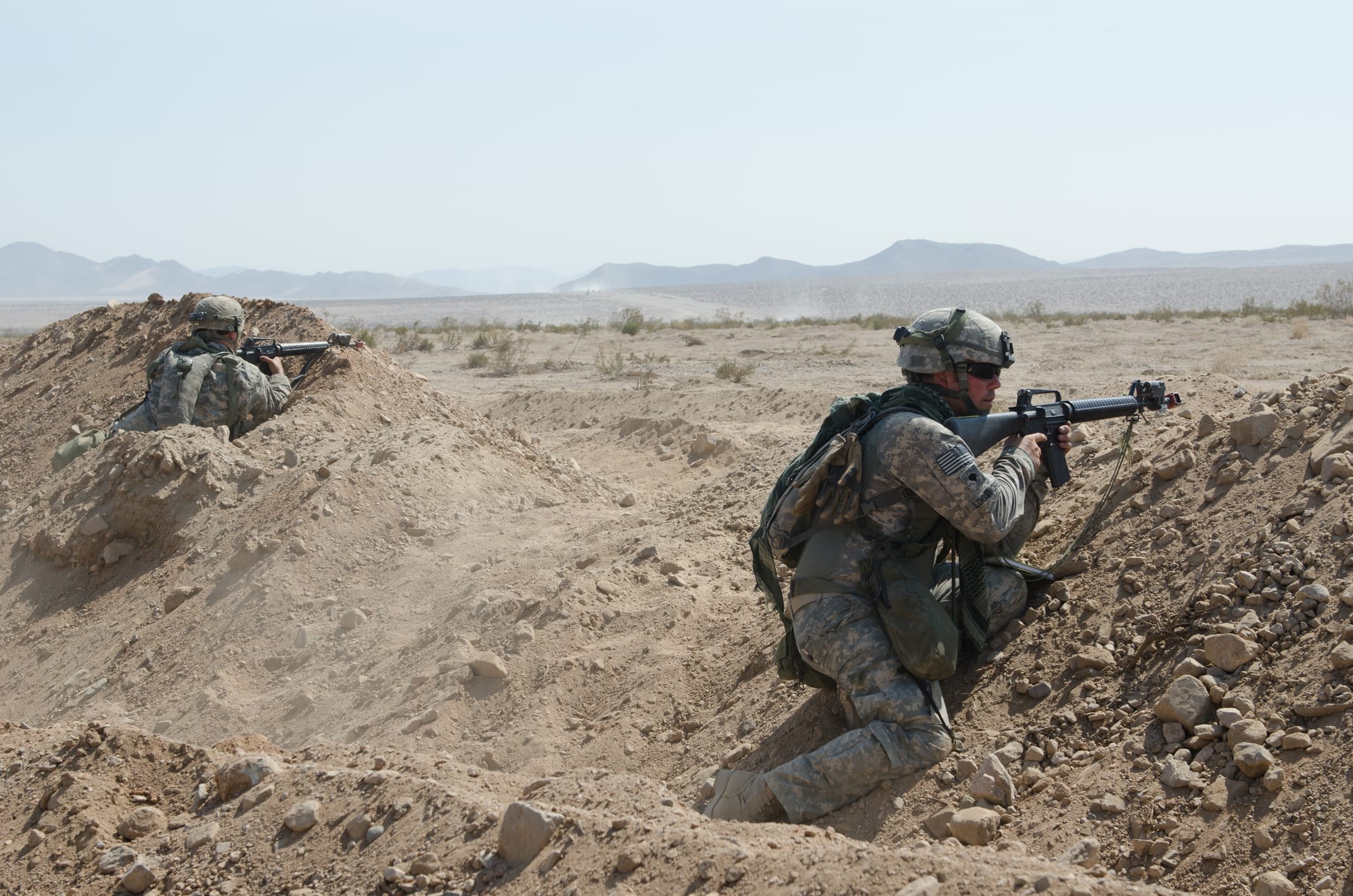 Two Idaho Army National Guard Soldiers from the 126th Engineer Company react to enemy fire during a field training exercise, at 'Tactical Assembly Area Snake' at the National Training Center, Fort Irwin, Calif., Aug. 18. The unit is supporting the 116th Cavalry Brigade Combat Team during a 12-day field training exercise that simulates life in a deployed status. This training cycle is the first force-on-force battle simulation the Army National Guard has participated in since the beginning of Operation Enduring Freedom, and is composed of more than 5,200 Soldiers from 10 states’ National Guard units, the U.S. Army Reserve, and active duty U.S. Army Soldiers. (Photo by Spc. Michael Germundson, 115th Mobile Public Affairs Detachment)
Unit: 115th Mobile Public Affairs Detachment
DVIDS Tags: Oregon; Fort Irwin; National Training Center; NTC; Ft. Irwin; U.S. Army National Guard; 126th Eng. Co.; 126th Engineer Company; Army horizontal construction; U.S. Army Ntional Guard