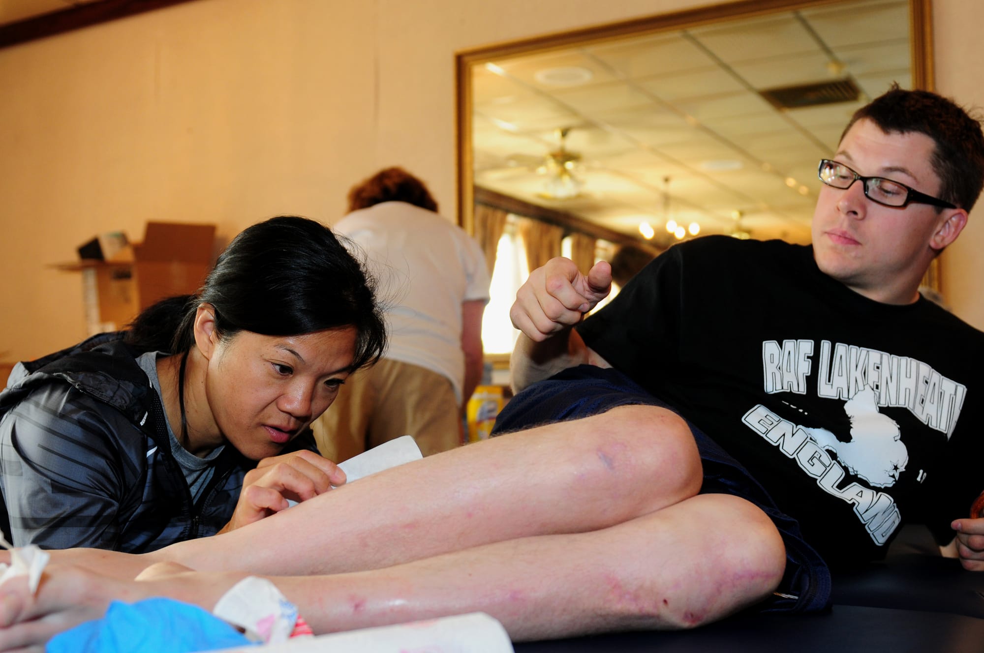 Josh Roberts, a U.S. Paralympian, is treated for a cut by Suzy Kim, a U.S. Paralympic team doctor, Aug. 22, 2012, at RAF Lakenheath, England. Roberts was competing in the 100-meter, 200-meter, 400-meter and 800-meter races. More than 50 U.S. Paralympians and hopefuls were honing their skills and making final preparations for competition in the 2012 Paralympic Games in London. The Paralympics is a major international sporting event in which thousands of athletes, including wounded and injured U.S. service members, participate in a variety of sporting events. (U.S. Air Force photo by Airman 1st Class Cory D. Payne/Released)
Unit: Defense Imagery Management Operations Center
