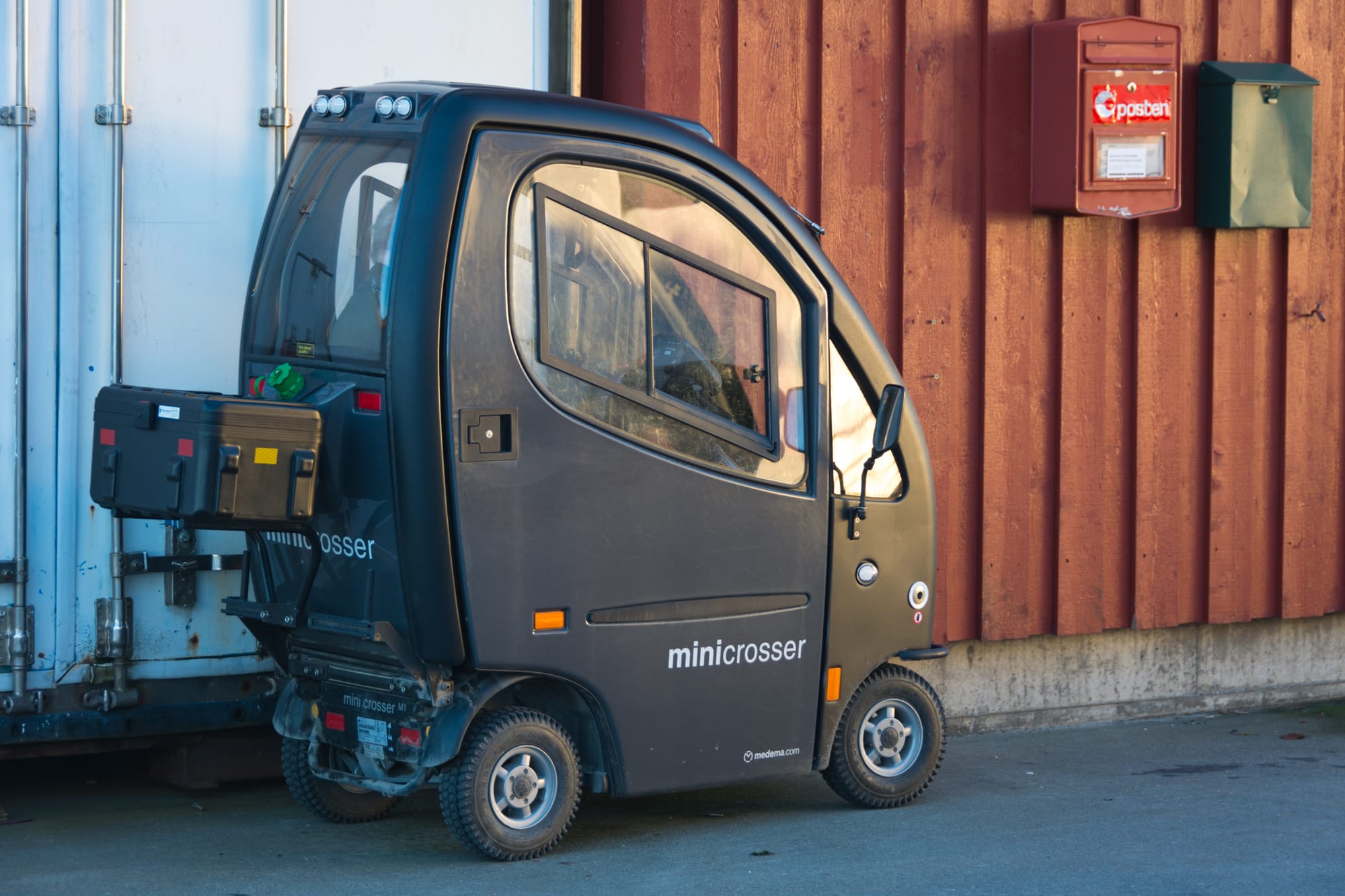Mini Crosser X-CAB mobility electric scooter with cabin on the dock at Nesna Harbor, Norway on November 20, 2016.