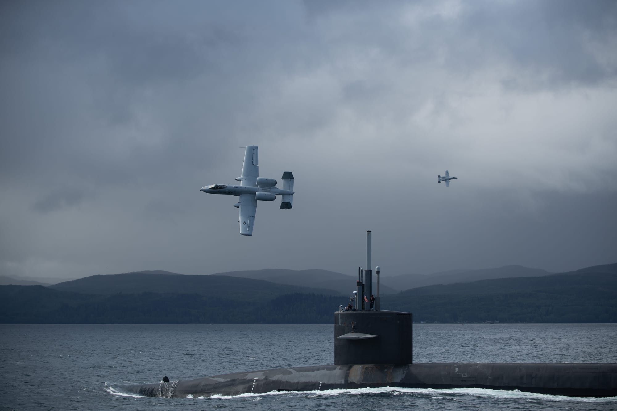 STRAIT OF SAN JUAN DE FUCA, Wash. (May 6, 2024) The Ohio-class ballistic missile submarine USS Nebraska (SSBN 739) transits the Strait of San Juan de Fuca escorted by U.S. Air Force A-10 Thunderbolt II aircraft and U.S. Coast Guard screening escort vessels. Joint operations, such as this one which involved the Air Force, Coast Guard, and Navy, ensure the U.S. military is ready to meet its security commitments at home and abroad including commitments to our allies and partners. (U.S. Navy photo by Mass Communication Specialist 2nd Class Gwendelyn Ohrazda/Released)