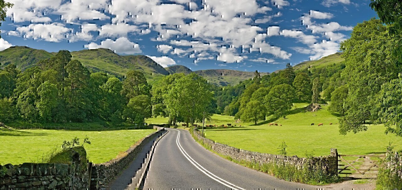 The A591 road as it passes through the countryside between Ambleside and Grasmere in the Lake District, England.