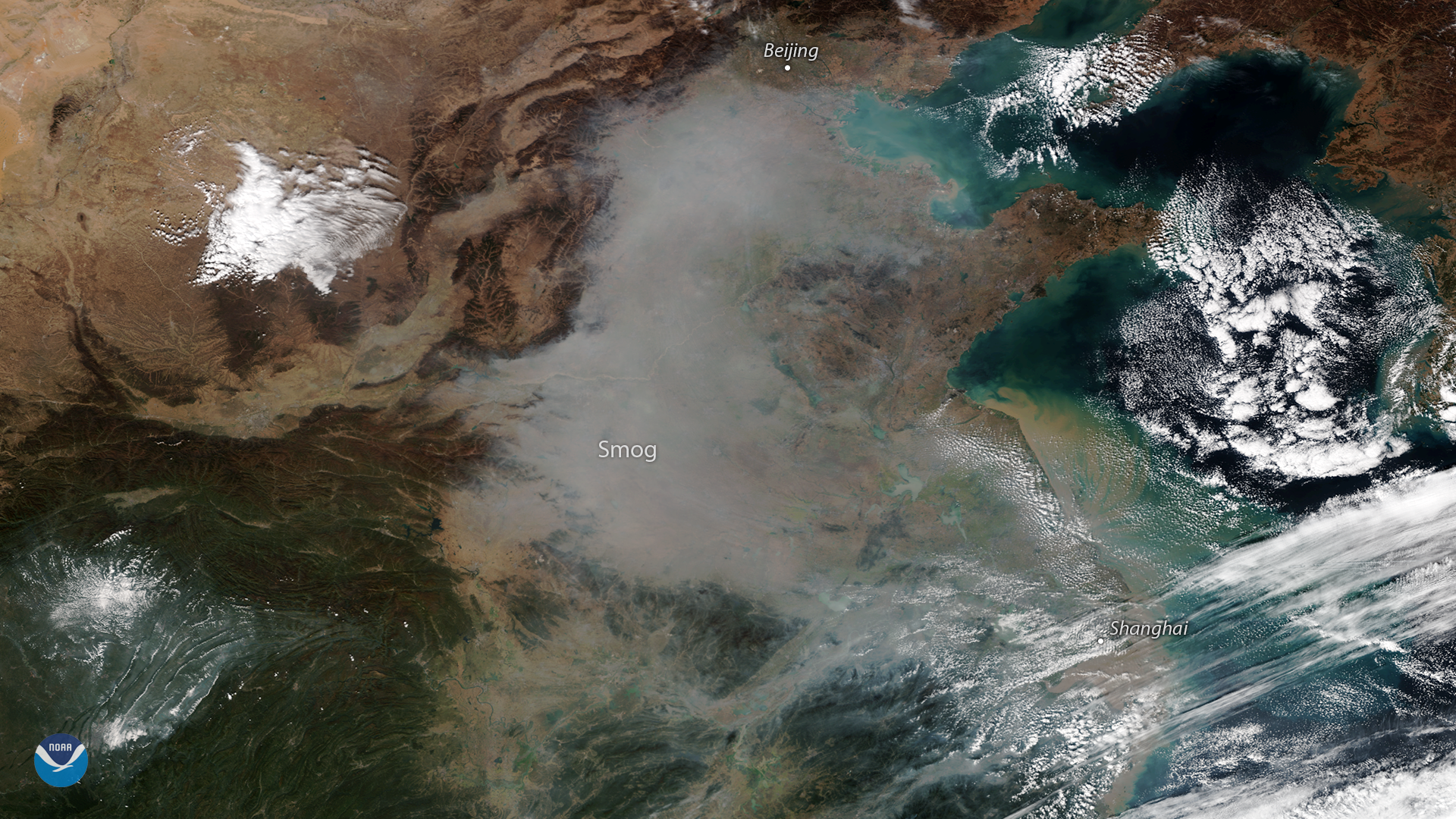 A plume of smog appears over northeastern China in this true-color image seen from the NOAA-20 satellite on October 31, 2018. While air quality in China has dramatically improved in recent years, thanks to ambitious government efforts to reduce coal consumption, pollution levels periodically still spike â€“ especially during the fall and winter months, when more coal is burned for residential and commercial heating. In recent days, air quality in Beijing has reached unhealthy levels. On November 2, air quality reports showed widespread fine particulate concentrations (PM2.5) above 200 micrograms per cubic meter in the Chinese capital,following several days of a high pressure weather pattern that trapped pollutants near the surface. In addition to the smog, we can see several other interesting features in this satellite imagery. The outermost cloud bands of former Typhoon Yutu (now a tropical depression) appear in the lower right, while a dusting of snow is visible in the mountainous highlands along the border of China's Sichuan and Shaanxi provinces in the lower left. The NOAA-20 satellite's VIIRS instrument provides global coverage twice per day with a 750-meter resolution across its entire span. Its multi-channel imaging capabilities allow us to detect atmospheric aerosols, such as dust, smoke, and haze associated with industrial pollution.