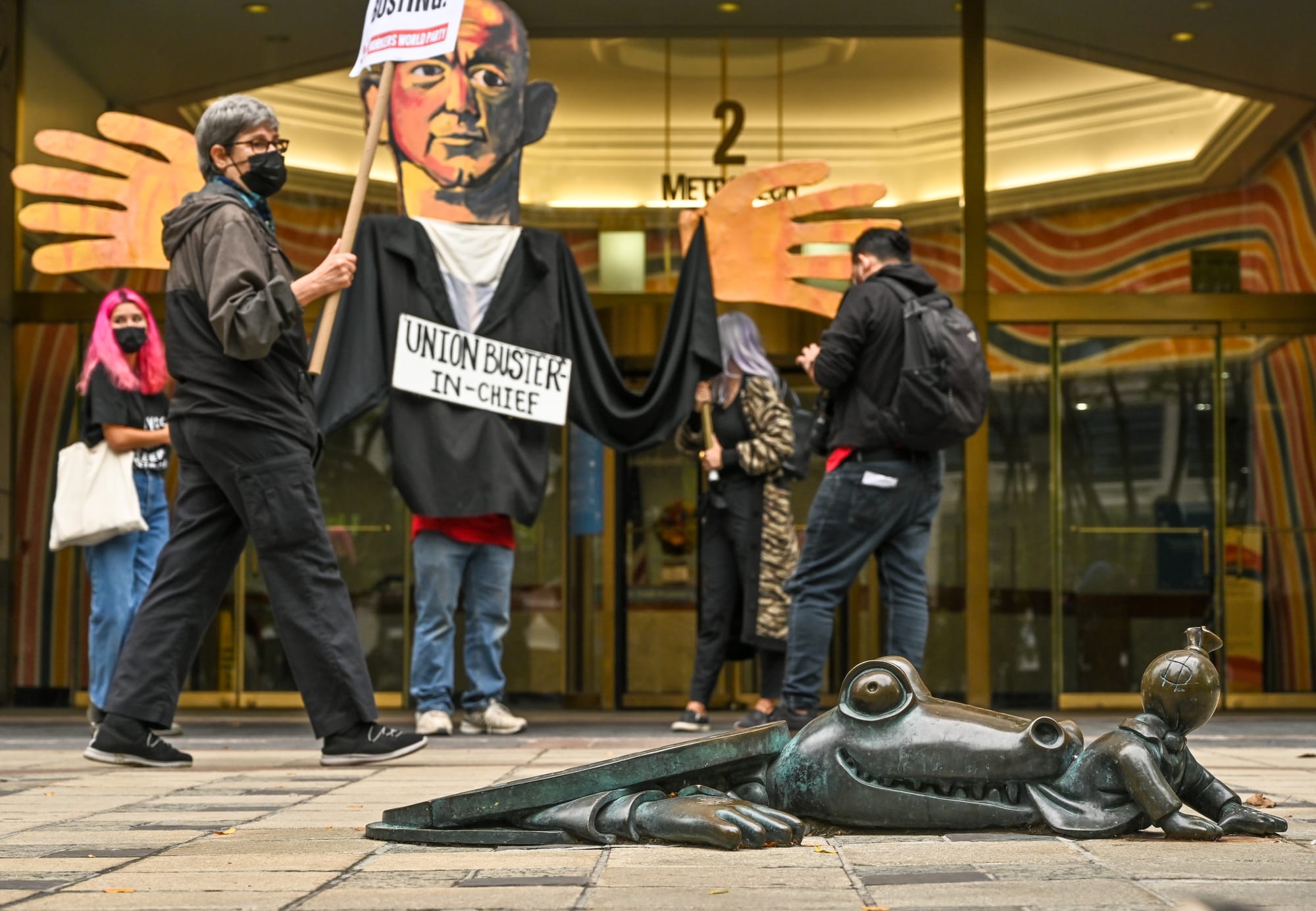 Amazon warehouse workers at four Amazon warehouses on Staten Island rallied outside the National Labor Relations Board and hand-carried four plastic containers filled with signed cards into a local labor office, petitioning it to authorize a union vote. 

Demonstrators chanted pro-union slogans against the background of a giant cutout of Jeff Bezos.

New York City, New York, U.S.
October 25, 2021

Photo by Joe Piette.