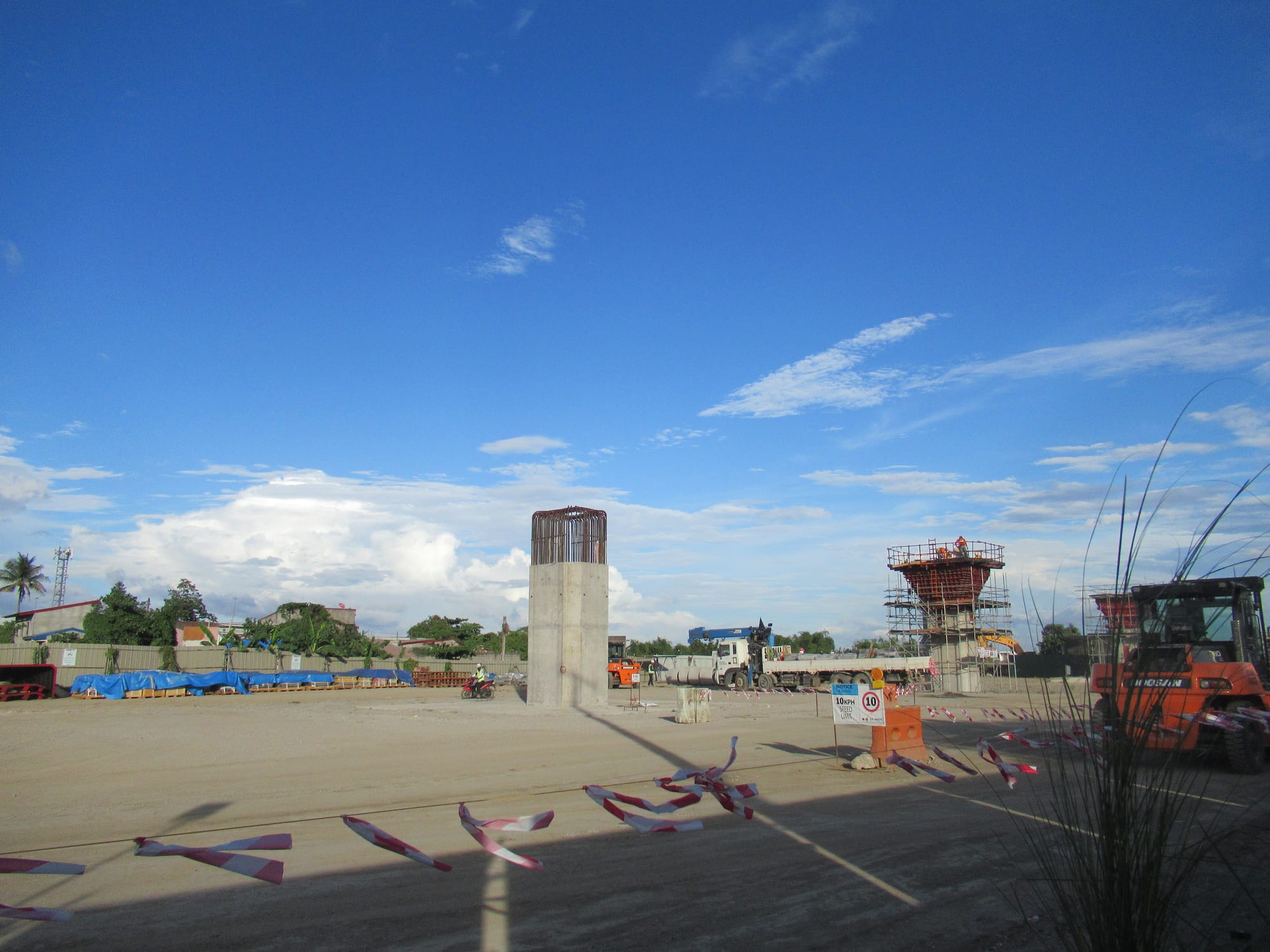 This and related photos were taken by me with my own camera at Sitio Sampaga, North and South, at Barangay San Vicente,  Apalit of and along  Apalit-Macabebe, Pampanga Road: Construction of 16.92 kilomers of elevated viaduct  (at km 34+749 to km 51+670) with 5 balanced  cantilever bridges, 2 storey (A-2 level) Apalit station, substations,  railway signalling houses (Apalit railway station is part of the second phase of the North–South Commuter Railway located in Sitio Sampaga, Barangay San Vicente,  Apalit, an elevated double-track railway  - standard-gauge railway   (Malolos-Clark Railway Project, Malolos City to Minalin, Pampanga - Contract Package N-01 - Contractors - Joint Venture: Hyundai Engineering & Construction  Megawide  and Dong-Ah Geological Engineering Co., Ltd.).