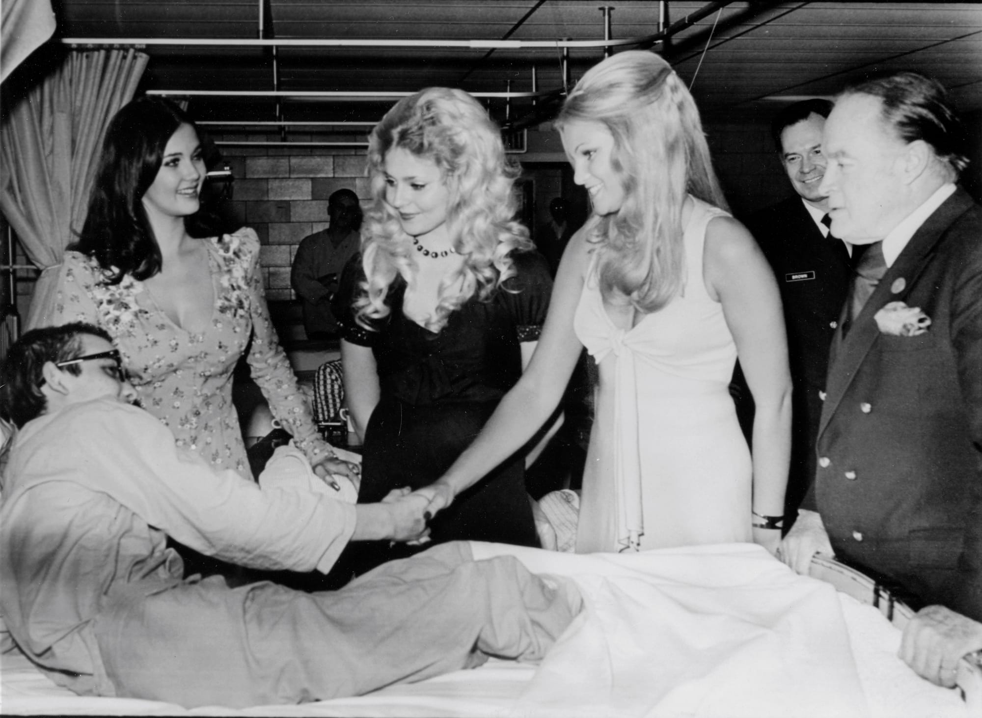 15-3001-1061
print 8x10 b&w
(left to right) Miss World - Miss USA Lynda Carter; Miss San Diego, Priscilla Barnes; and Miss Maryland, Betty Jo Grove accompany Bob Hope and spread Christmas cheer at the National Naval Medical Center, Bethesda, MD. 
Published in Nov-Dec 1993 Navy Medicine Magazine marked 1972

[1]