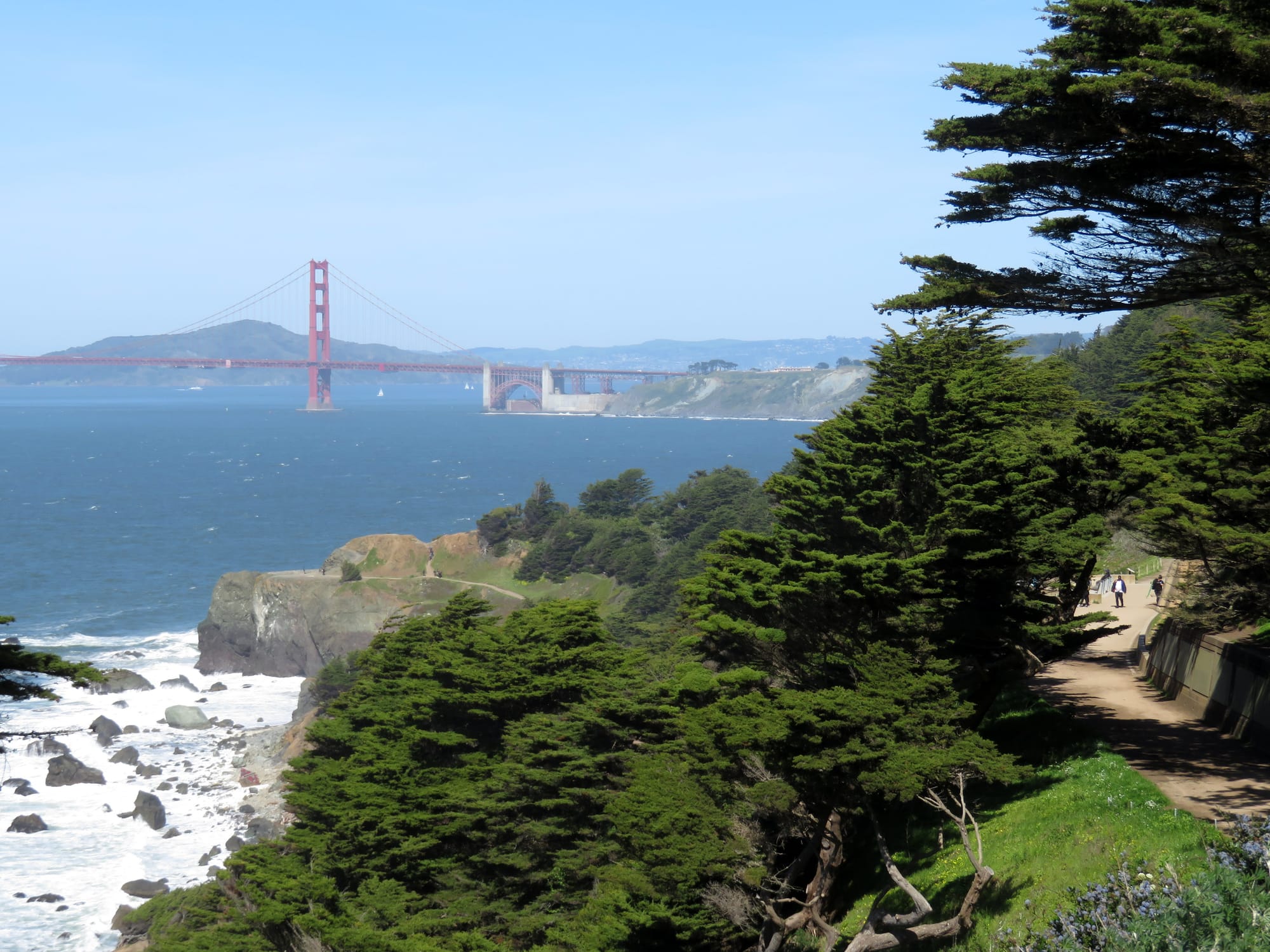 Golden Gate Bridge and the Coastal Trail viewed from the Lands End Trail parking lot in April 2019