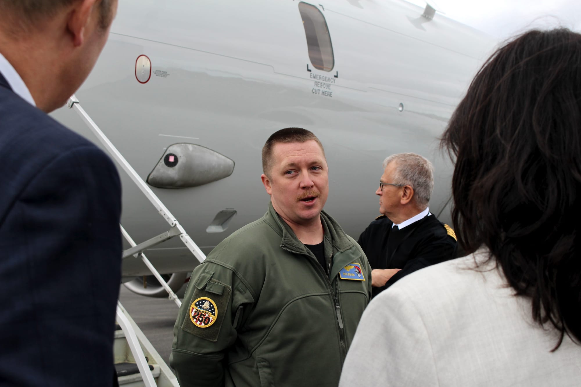 KEFLAVÍK, Iceland (July 4, 2025) - Cmdr. Eric Bowen, commanding officer, Patrol Squadron (VP) 46, answers questions about P-8A Poseidon aircraft capabilities from members of the Defense and Security Committee, NATO Parliamentary Assembly, outside the aircraft during a tour at Keflavík Air Base, Iceland, July 4, 2025. VP-46 and VP-69 are on a joint deployment in the U.S. 6th Fleet area of operations to support warfighting effectiveness, lethality and readiness of U.S. Naval Forces Europe-Africa, and defend U.S., Allied and partner interests in the region. (U.S. Navy photo by Lt. Sara Wedemeyer)