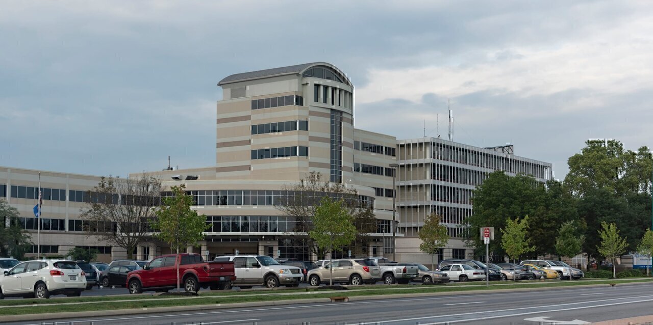 A southwest view of the front of Doctors Hospital, located on Broad Street (U.S. Route 40). A couple of license plates were slightly blurred to protect their right to privacy at a hospital.
