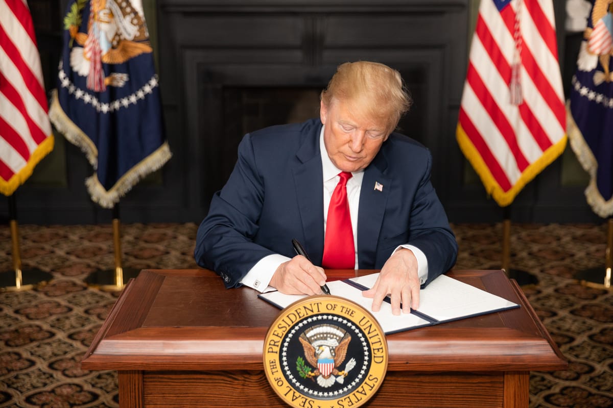 President Donald J. Trump signs an EO on Iran Sanctions in the Green Room at Trump National Golf Club Sunday, August 5, 2018, in Bedminster Township, New Jersey.  (Official White House Photo by Shealah Craighead)