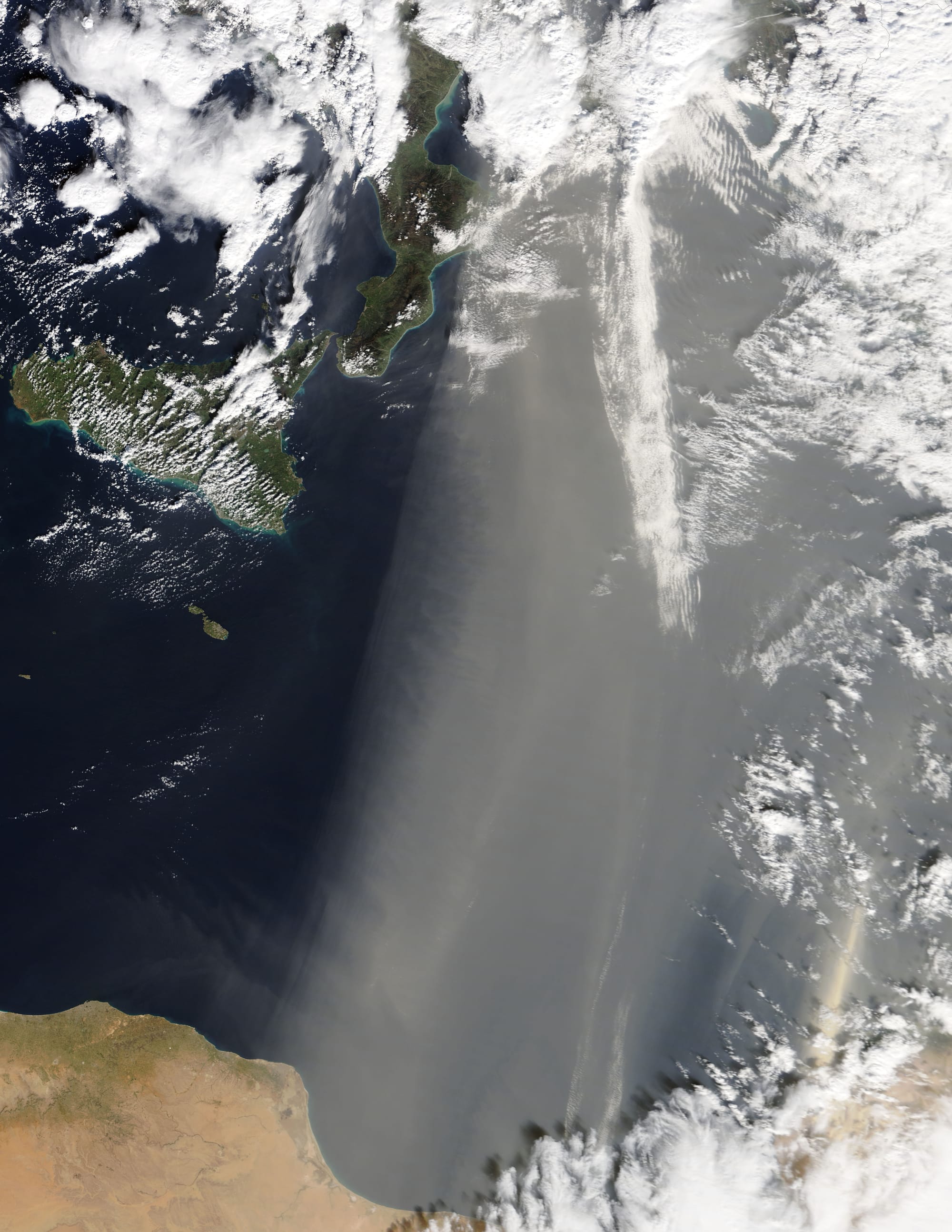 On February 7, 2018, the Moderate Resolution Imaging Spectroradiometer (MODIS) on NASA’s Terra satellite acquired this true-color image of dust from the Sahara blowing over the Mediterranean Sea toward southern Europe.
According to news reports, the dust was carried by winds known as the scirocco. (In North Africa, these same desert winds are known as “chrom” (hot) or “arifi” (thirsty). The warm, dry air mass begins over the Sahara, picks up moisture over the Mediterranean, and moves north toward areas of lower pressure along the coasts of Europe.

The dust can be seen making its way toward Italy, and then continues to countries to the north (beyond this image). According to local news reports, the winds brought above average temperatures to Italy, while the sand increased the chance of rain. The fine sand particles can act as a “seed” on which water droplets can form fog or fall as rain. In Italy’s coastal areas, cars were covered with a layer of dust.