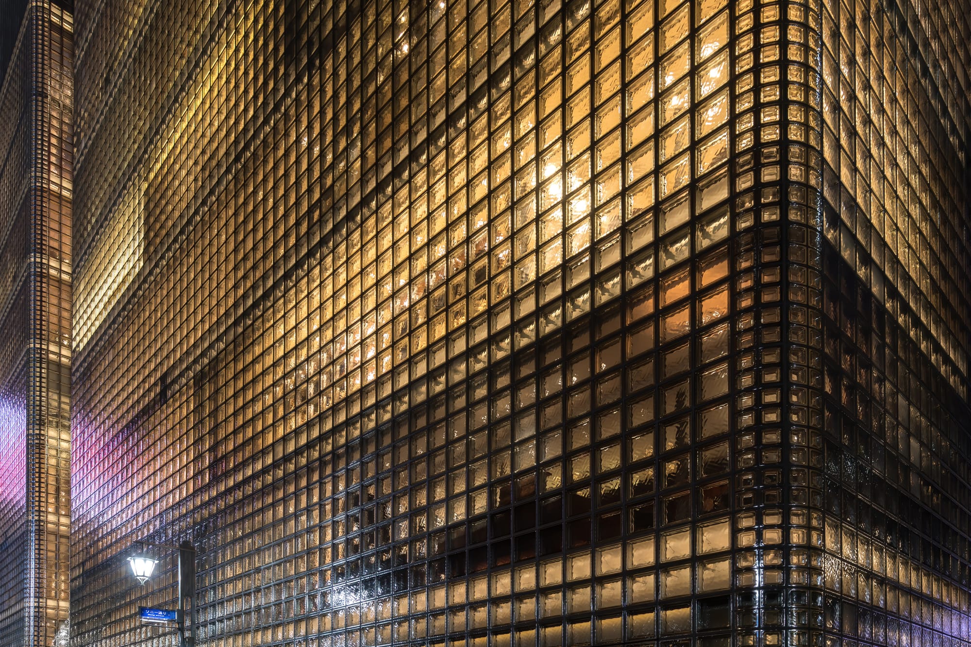 Exterior view of the illuminated facade of the building Maison Hermès made of glass blocks, and located at 5-4-1 Ginza, Chuo-ku, Tokyo, Japan. Constructed between 1998 and 2001, it was designed by Renzo Piano assisted by Bohlin Cywinski Jackson and in collaboration with Takenaka Corporation. The building is the flagship store and corporate headquarters of Hermès.