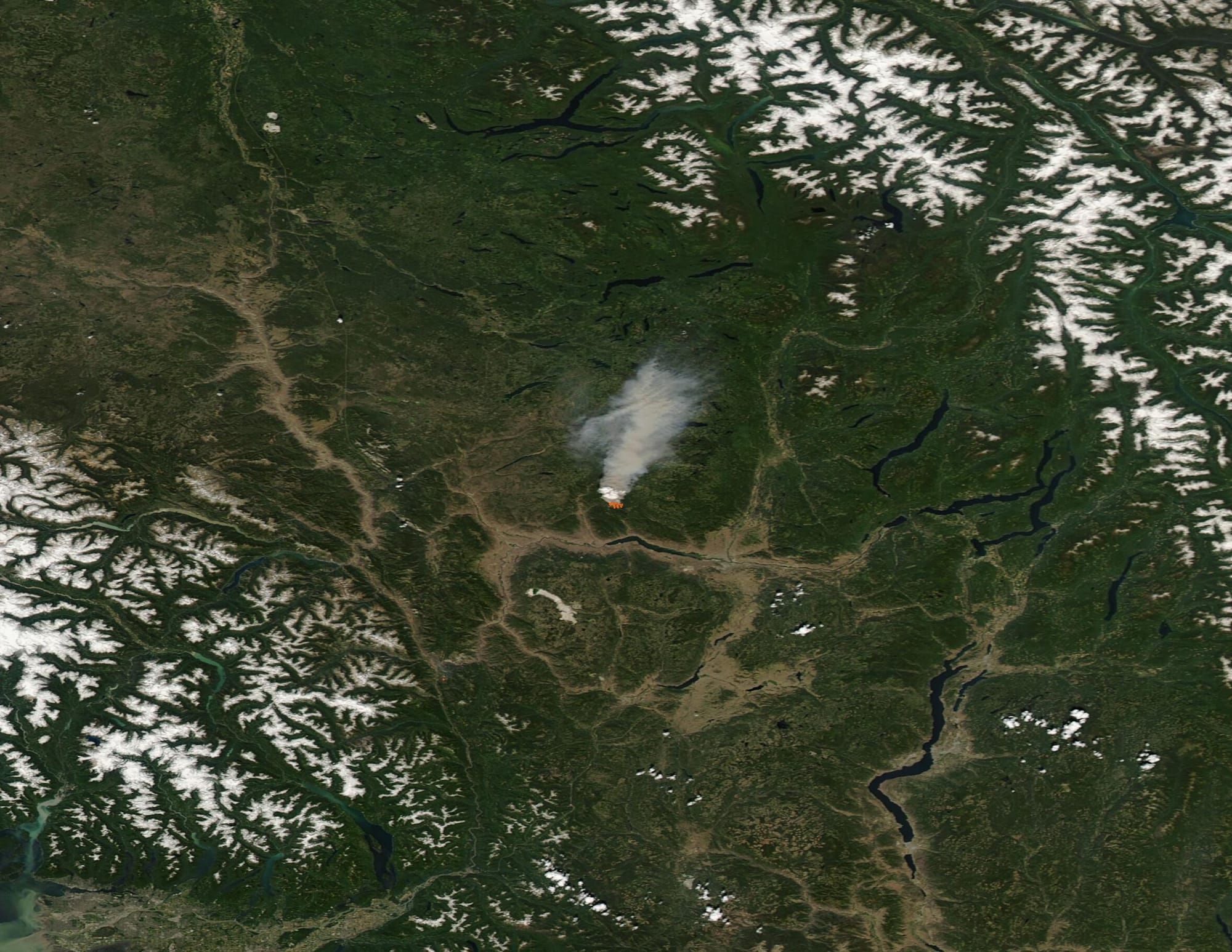Extreme heat and high wind contributed to an early and angry start to the summer fire season in British Columbia, Canada. According to the B.C. Wildfire Dashboard, there have been 416 wildfires in the province since January 1, 2021, with 51 of those reported during the last week. On June 30, there were 41 active wildfires burning in British Columbia, which is an increase of 26 fires in the last two days alone.
Record-breaking heat has gripped Western Canada and the Western United States over the last several days, driving dangerous fire conditions. The British Columbia Wildfire Service’s Daily Danger Rating on June 30 showed at least three-quarters of the province at Extreme or High Fire Danger.
All-time high temperature records have been broken repeatedly across British Columbia since June 25. The village of Lytton, which sits north of Vancouver at the confluence of the Fraser and the Thompson Rivers, broke record high daily and all-time temperatures for all of Canada—three days in a row. The previous record of 45˚C (113˚F) was set in Saskatchewan in 1937. On June 27, Lytton edged ahead with 46.1˚C (115˚F) and the next day the temperature reached 47.9˚C (118.2˚F). The record was shattered once again as temperatures hit 49.5˚C (121˚F) on June 29. On the heels of the extreme heat, a fire sparked in Lytton, a town of about 250 people, causing an evacuation order for the entire town. Social media posts claim that the fire erupted so fast that people only had time to get to their cars and leave, and that several buildings have been engulfed.
On June 29, the Moderate Resolution Imaging Spectroradiometer (MODIS) on board NASA’s Aqua satellite acquired a true-color image of another fire burning in British Columbia. This is the Sparks Lake Fire, which sparked to life on June 28 just 15 miles north of Kamloops Lake. With extreme fire behavior, the fire quickly exploded to affect about 4,000 hectares (9,884 acres) by June 30. The Sparks Lake Fire is currently listed as “out of control”.

High temperatures and gusting winds not only aid fire ignition and growth across British Columbia but have also made firefighting difficult. A tweet by the BC Wildfire Service on June 30 read, “The hot weather continues to cause challenges. Multiple helicopters had to shut down due to engines overheating. Suppression efforts were impacted due to the helicopters restricted lifting capacity in heat, limiting the amount of water they can put in their buckets at a time.”