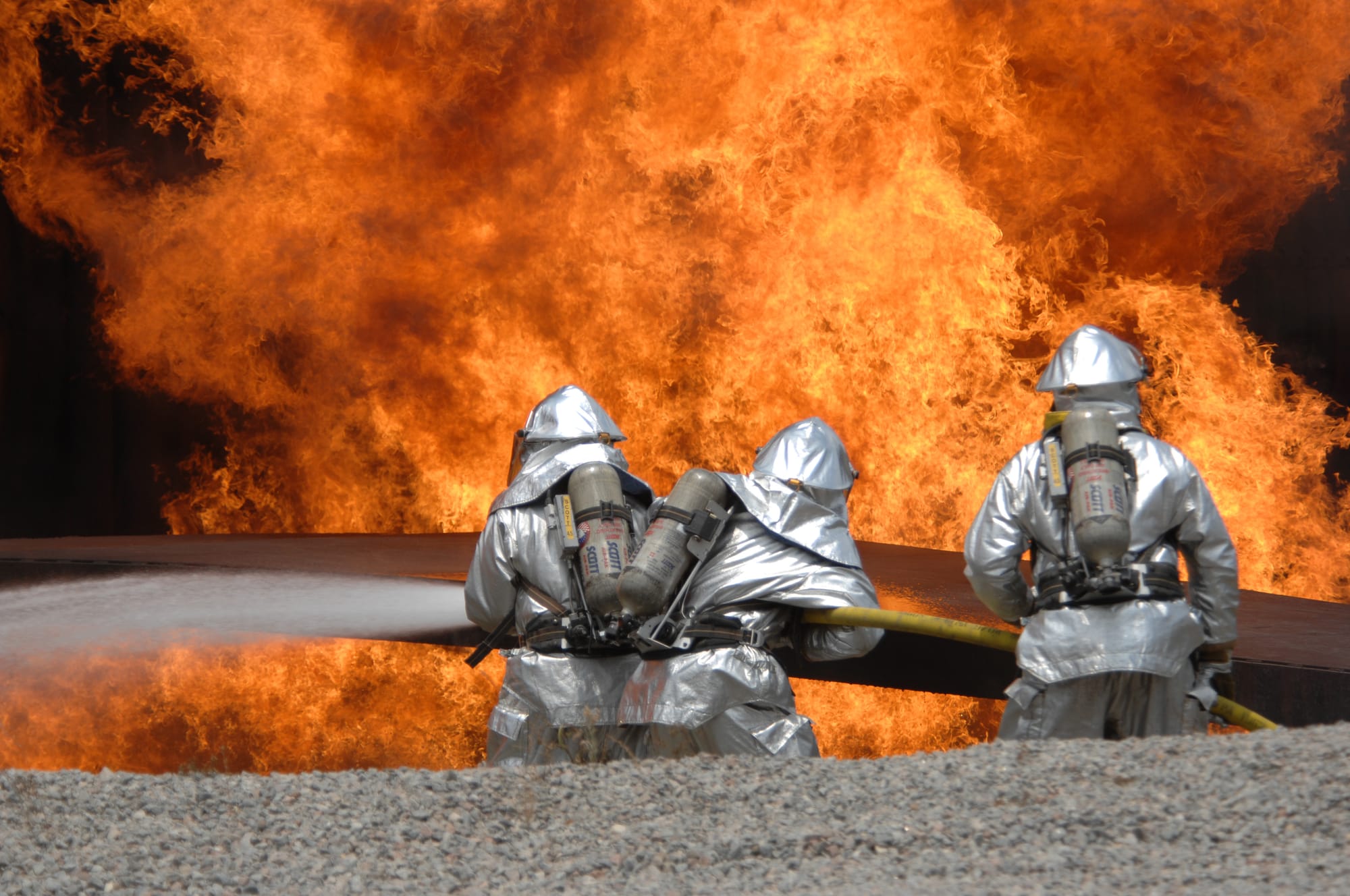 United States Air Force Airmen from the 20th Civil Engineer Squadron Fire Protection Flight neutralize a live fire during a field training exercise at Shaw Air Force Base in South Carolina May 23, 2007. The exercise includes training in self-aid buddy care, expedient firefighting, weapons handling, and night-vision devices.