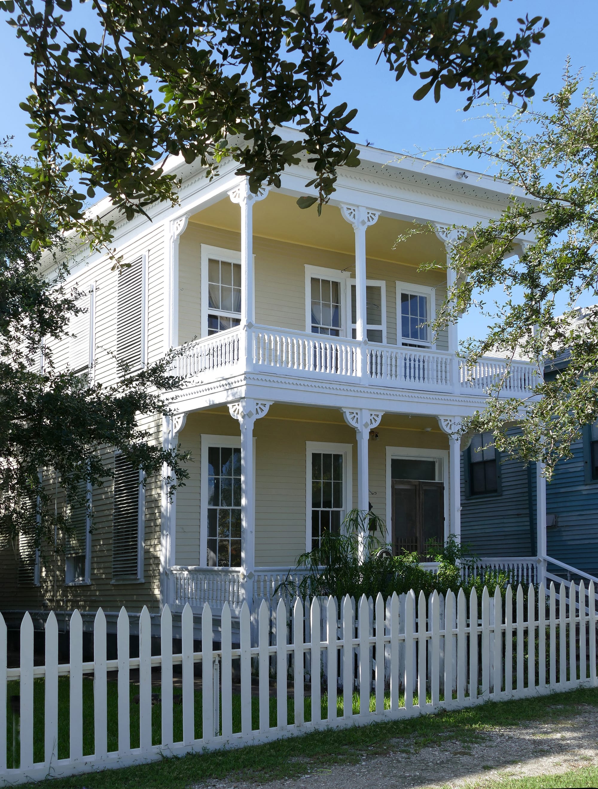 Originally this house was called the "Miller-Jacobs Home." Today it is called the "Jacobs Home"
In 1884, Mrs. Barbara Lenz (Lentz) Jacobs (1831-1908), the widow of Christopher Jacobs, purchased a small cottage on this lot from Ferdinand and Caroline Möller (Miller). In 1885, Mrs. Jacobs, a prominent midwife, built a new, two-story house designed by well-known Texas architect, Nicholas J. Clayton, for her family of six children. The home is a three-bay, double-gallery, side-hall plan with unusually pierced eaves, designed with particular attention to the Galveston climate. This Victorian-style town home was occupied for 84 years by three generations of the Jacobs family. Recorded Texas Historic Landmark - 1977